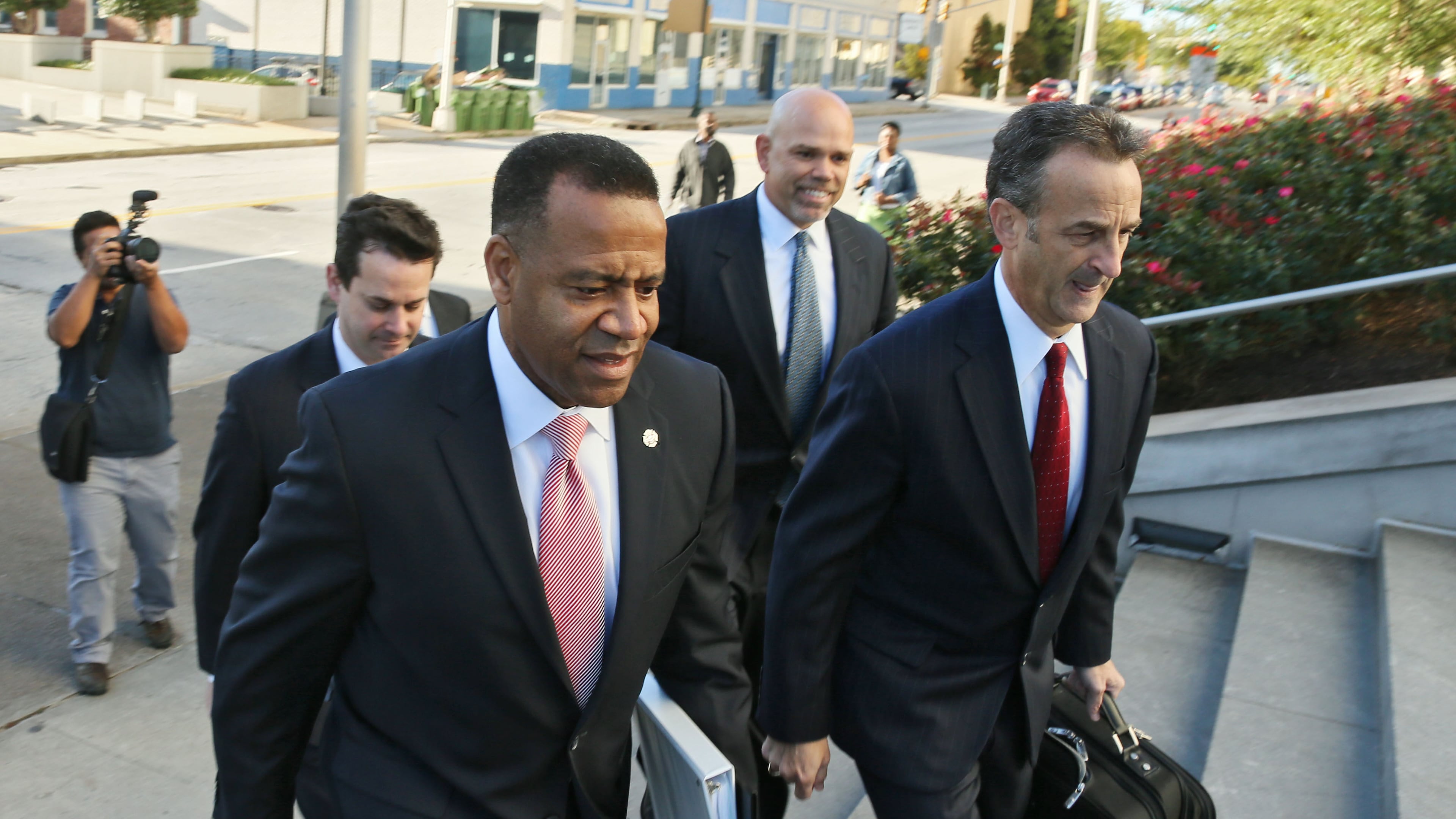 Former Atlanta Fire Chief Kelvin Cochran (left) arrives at federal court for a hearing over his wrongful-termination lawsuit against Atlanta, Oct. 14. (AJC Photo / Bob Andres)