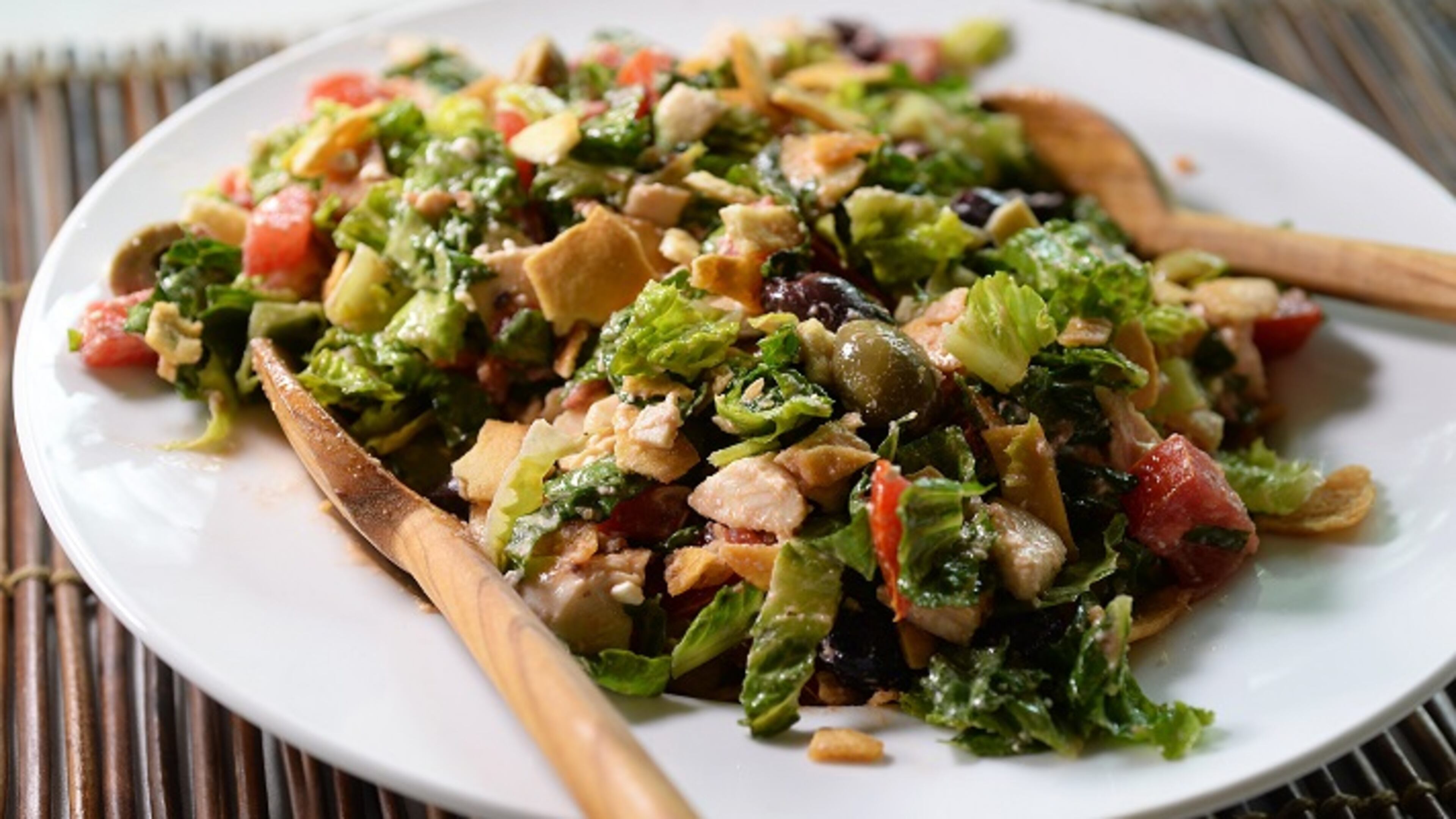 Greek chicken salad is finished off with crumbled pita chips. (Diedra Laird/Charlotte Observer/TNS)