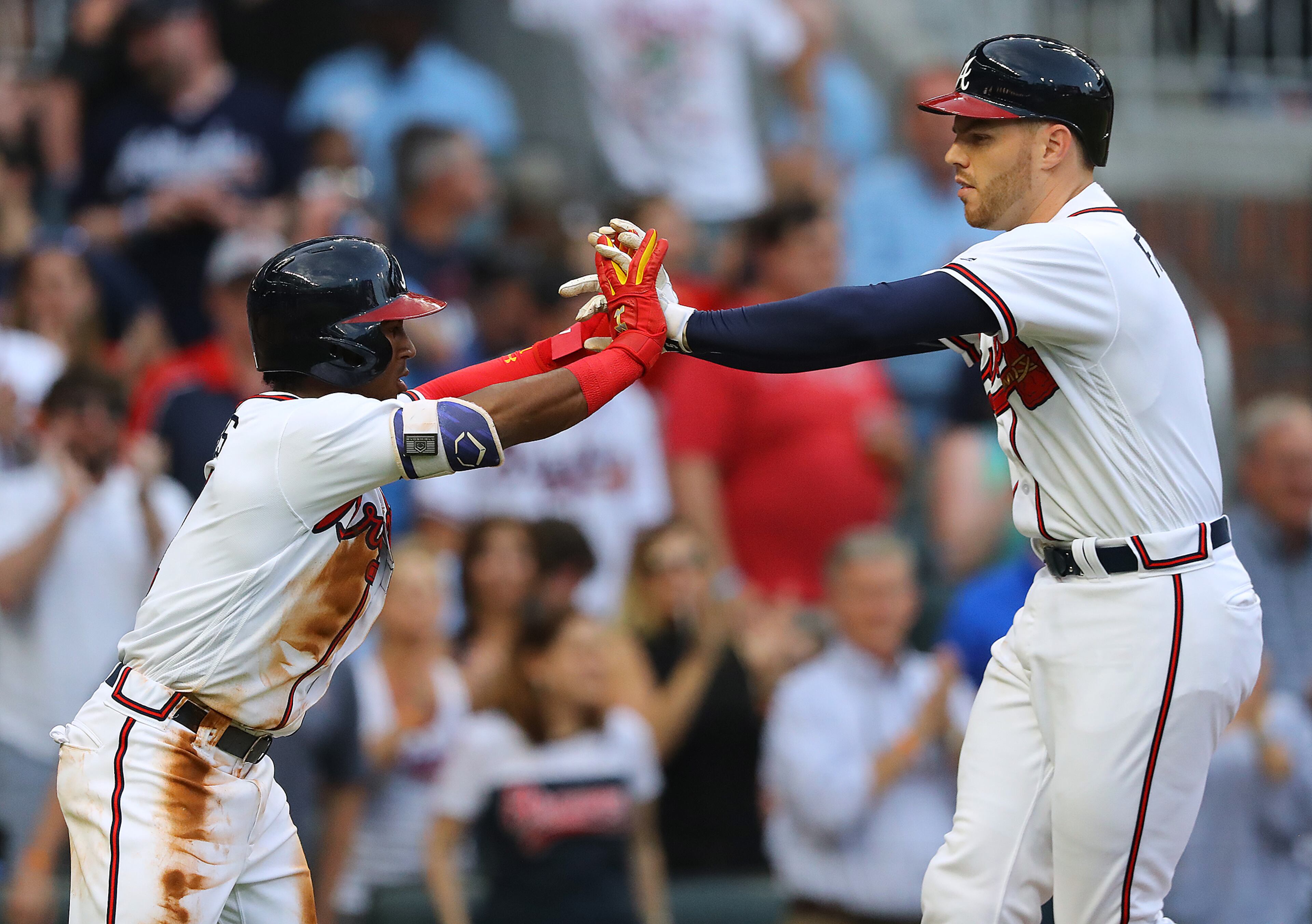 May 4, 2018 Atlanta: Atlanta Braves Freddie Freeman gets five from Ozzie Albies, hitting a 2-RBI home run for a 2-0 lead over the Giants during the first inning in MLB baseball game on Friday, May 4, 2018, in Atlanta. Curtis Compton/ccompton@ajc.com