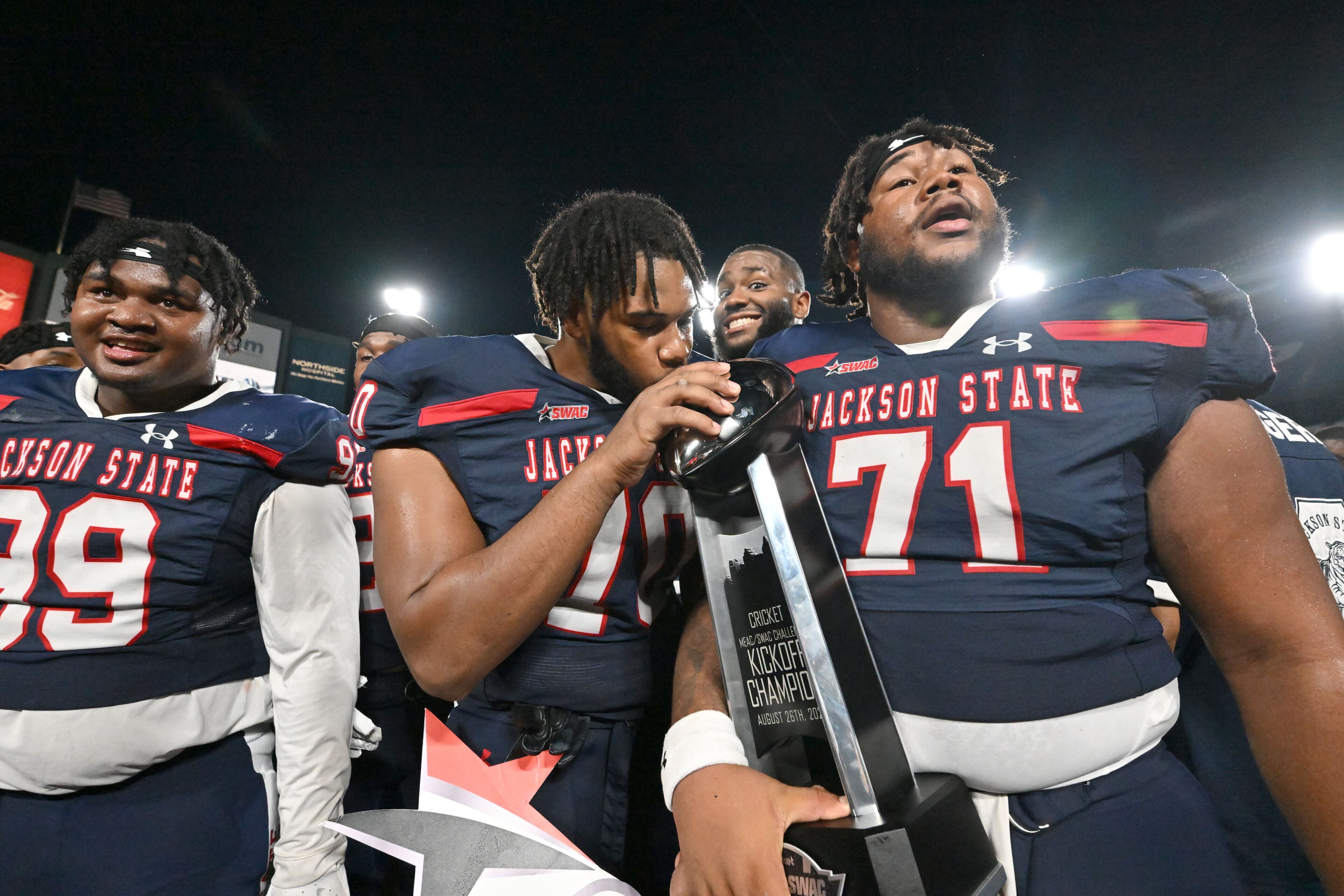 Jackson State players celebrate with the trophy during the 2023 MEAC/SWAC Challenge at Center Parc Stadium, Saturday, August 26, 2023, in Atlanta. Jackson State won 37-7 over South Carolina State. (Hyosub Shin / Hyosub.Shin@ajc.com)