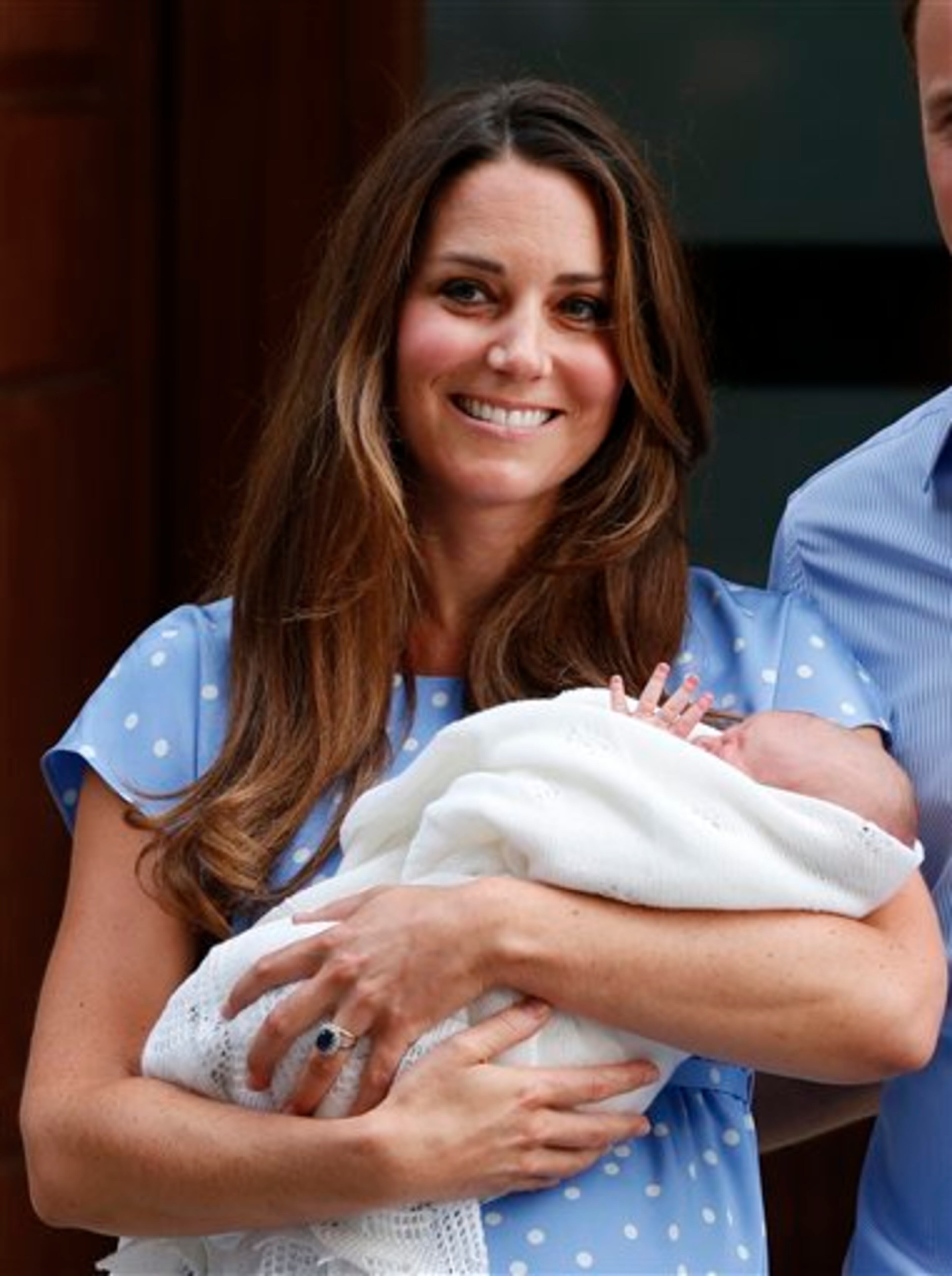 Kate, Duchess of Cambridge holds the Prince of Cambridge, Tuesday July 23, 2013, as she poses for photographers outside St. Mary's Hospital exclusive Lindo Wing in London where the Duchess gave birth on Monday July 22. The Royal couple are expected to head to London�s Kensington Palace from the hospital with their newly born son, the third in line to the British throne. (AP Photo/Lefteris Pitarakis)
