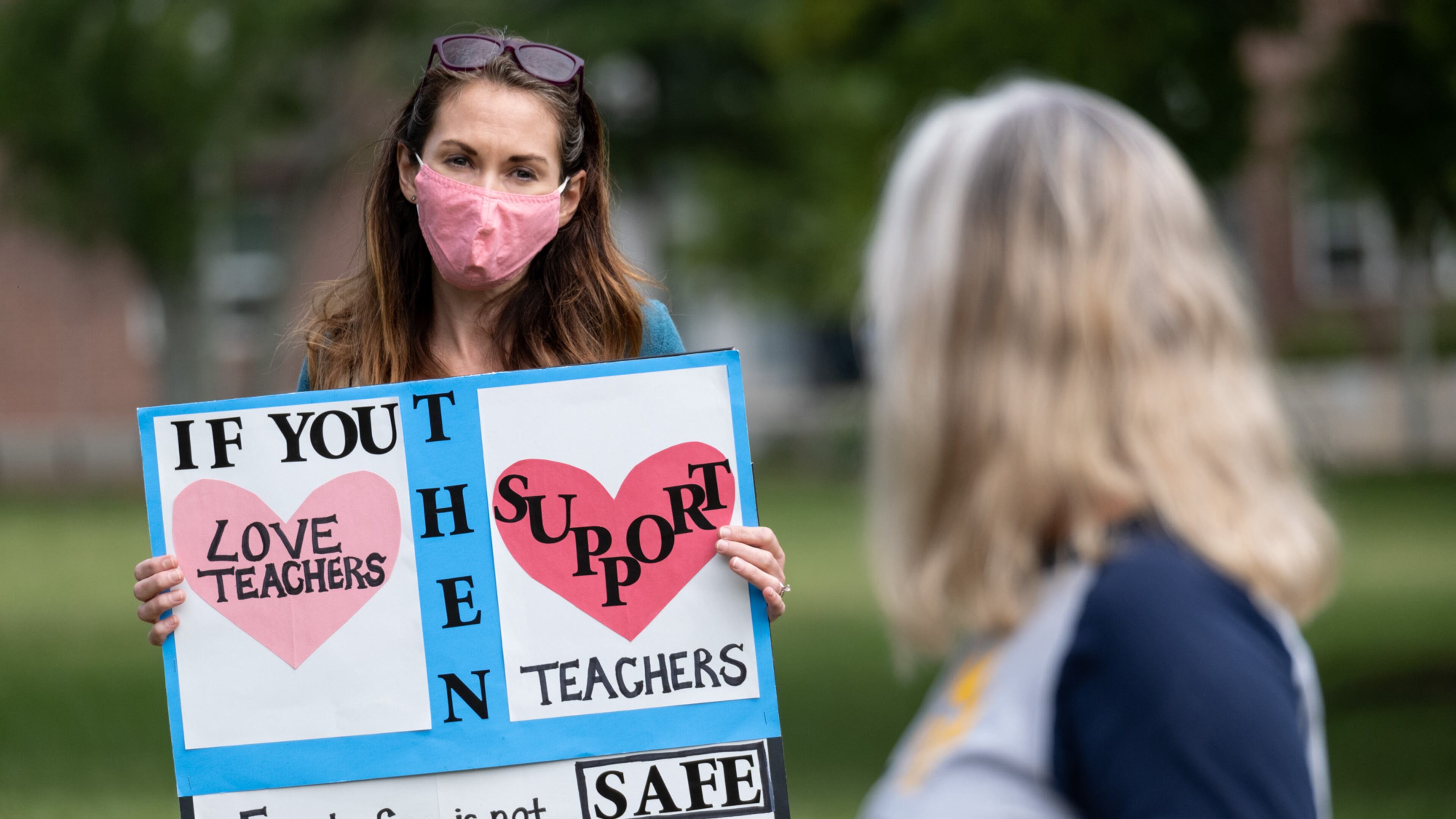 Katie Jonker, a former teacher’s assistant in Decatur who is also the parent of two Decatur High School students, protests the City Schools of Decatur plan to reopen in-person learning by gathering in front of the school’s headquarters in downtown Decatur on Tuesday, Sept. 22, 2020. Ben Gray for the Atlanta Journal-Constitution