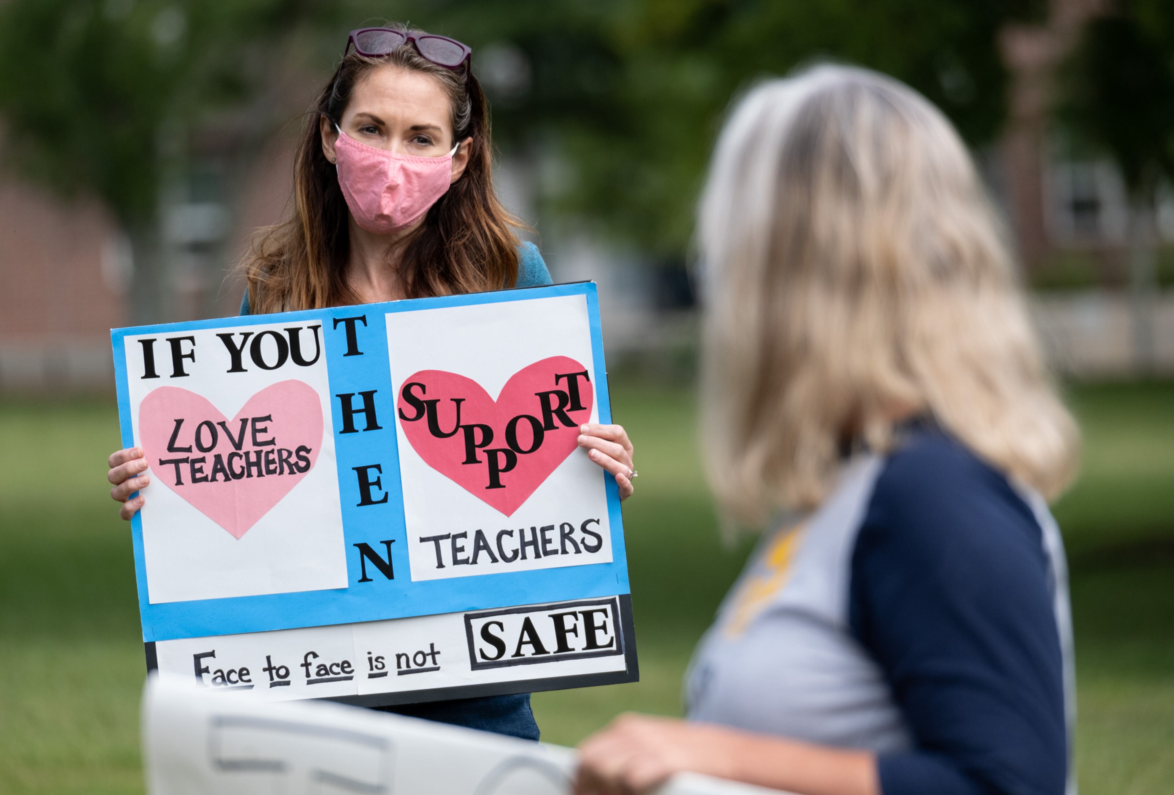 Katie Jonker, a former teacher’s assistant in Decatur who is also the parent of two Decatur High School students, protests the City Schools of Decatur plan to reopen in-person learning by gathering in front of the school’s headquarters in downtown Decatur on Tuesday, Sept. 22, 2020. Ben Gray for the Atlanta Journal-Constitution