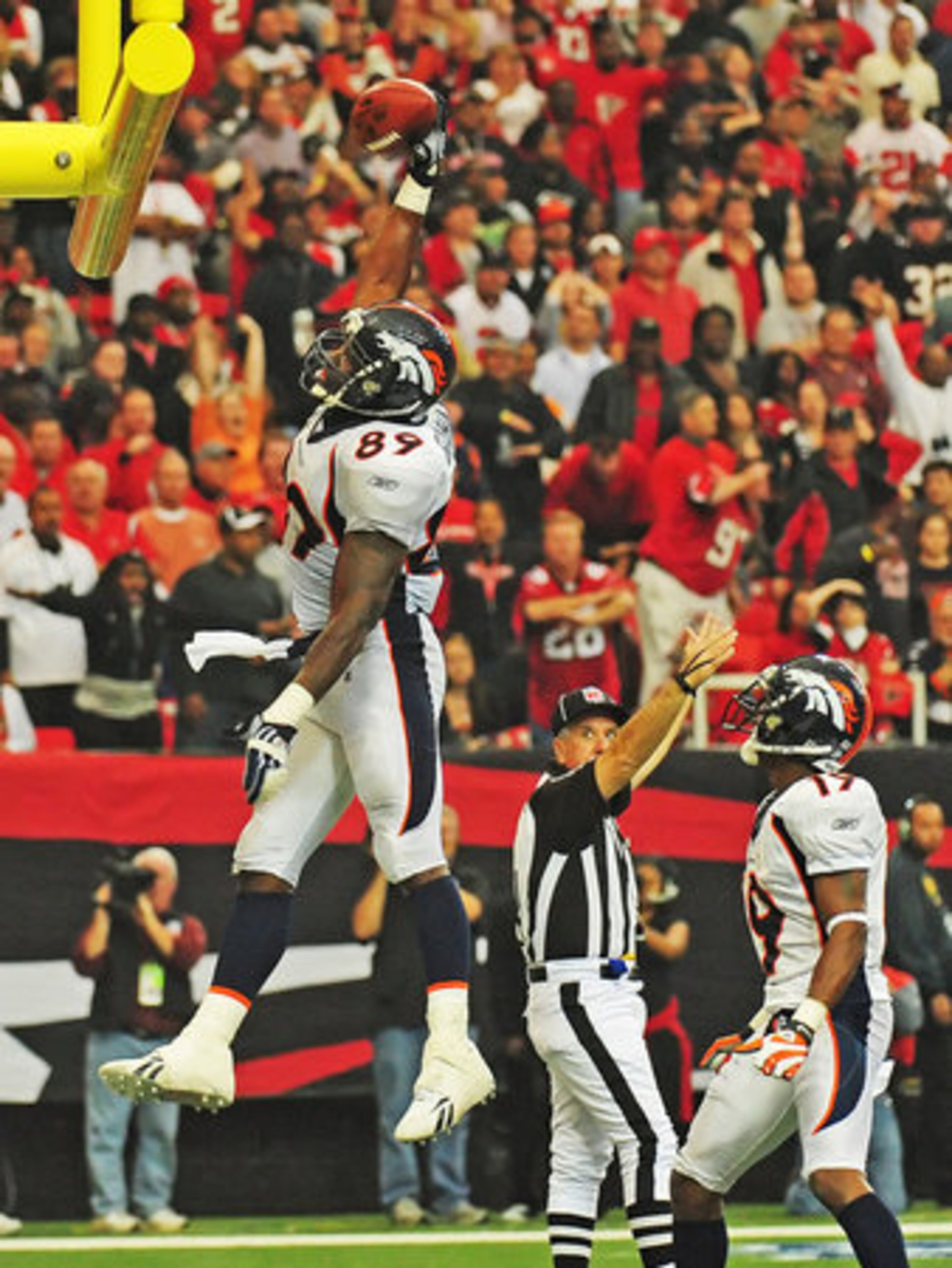Broncos tight end Daniel Graham slam dunks the ball over the goal posts after catching what would be the game-winning touchdown.