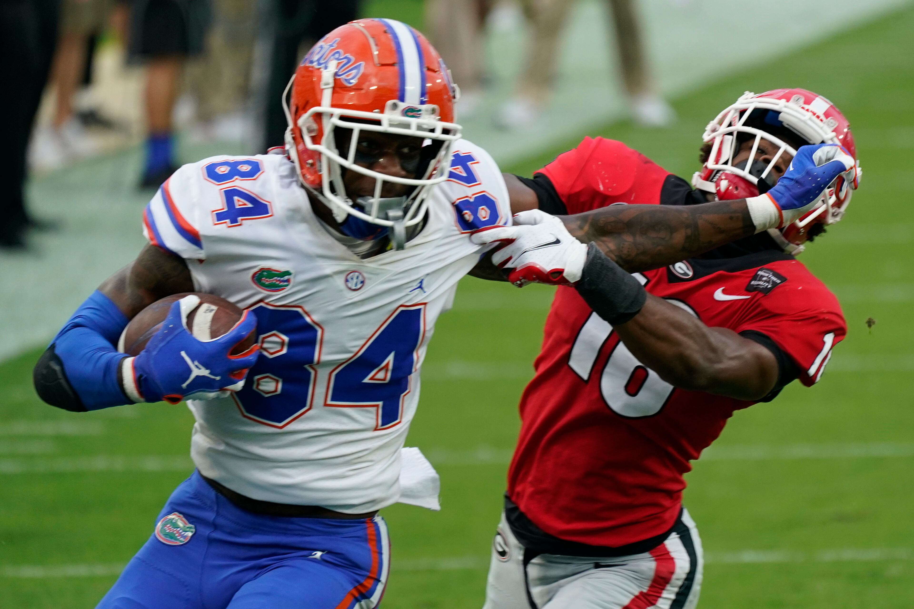 Florida tight end Kyle Pitts (84) tires to get past Georgia defensive back Lewis Cine (16) after a reception. (AP Photo/John Raoux, File)