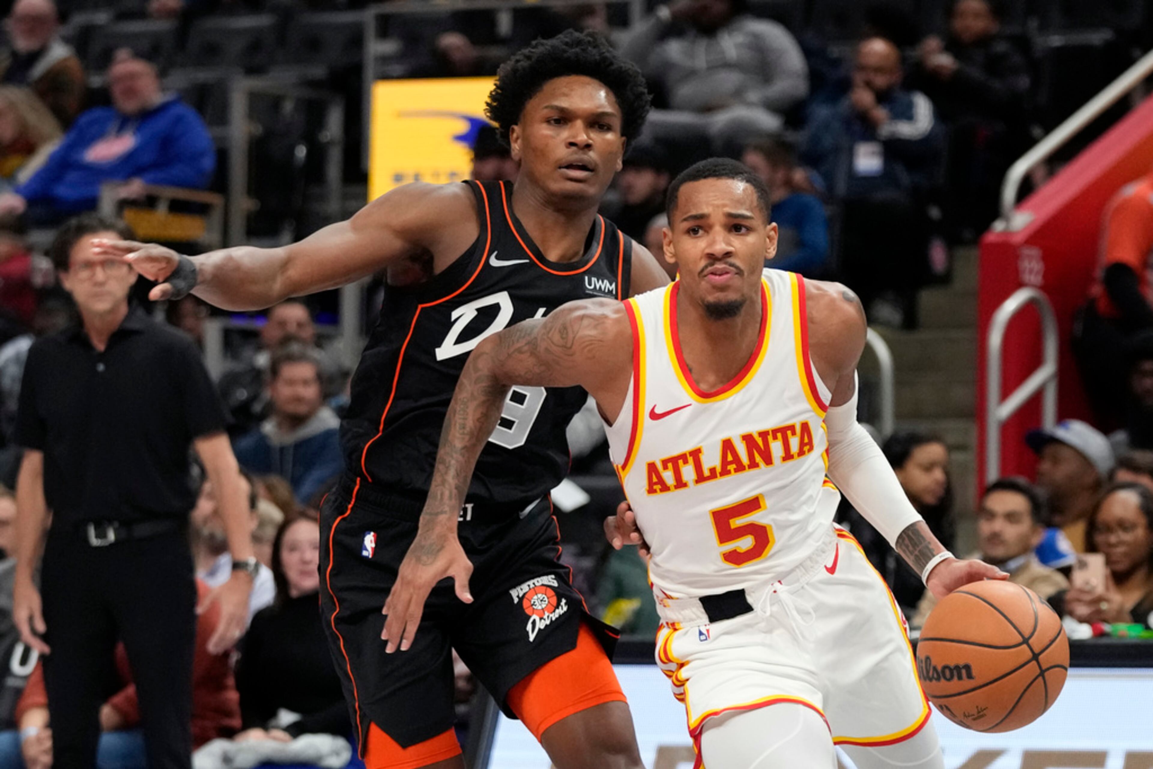 Atlanta Hawks guard Dejounte Murray (5) drives as Detroit Pistons forward Ausar Thompson (9) defends during the first half of an NBA basketball game, Tuesday, Nov. 14, 2023, in Detroit. (AP Photo/Carlos Osorio)