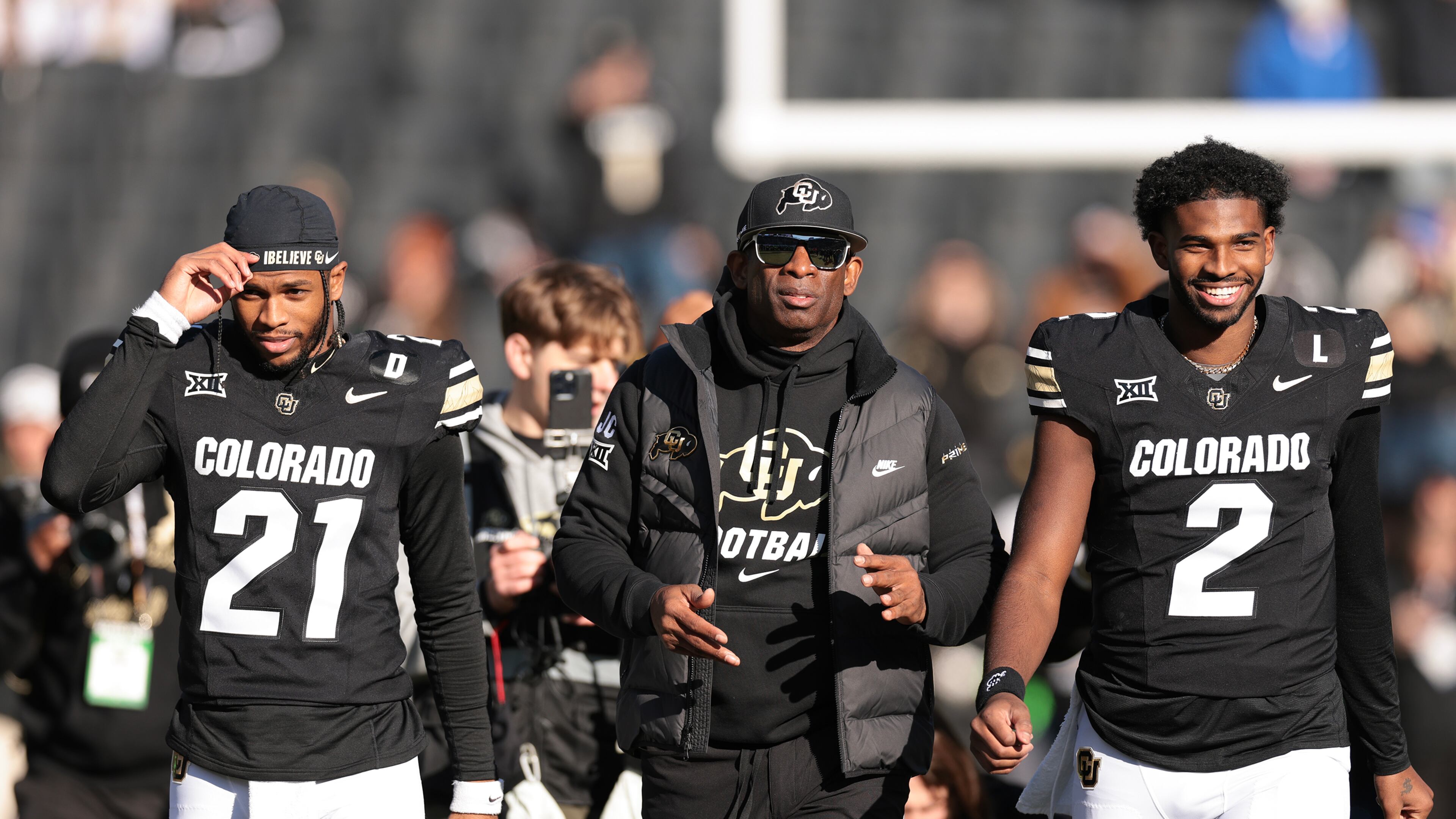 (L-R) Shilo Sanders (21), Head coach Deion Sanders and Shedeur Sanders (2) of the Colorado Buffaloes walk the field during senior day celebrations prior to the game against the Oklahoma State Cowboys at Folsom Field on Nov. 29, 2024, in Boulder, Colorado. (Andrew Wevers/Getty Images/TNS)