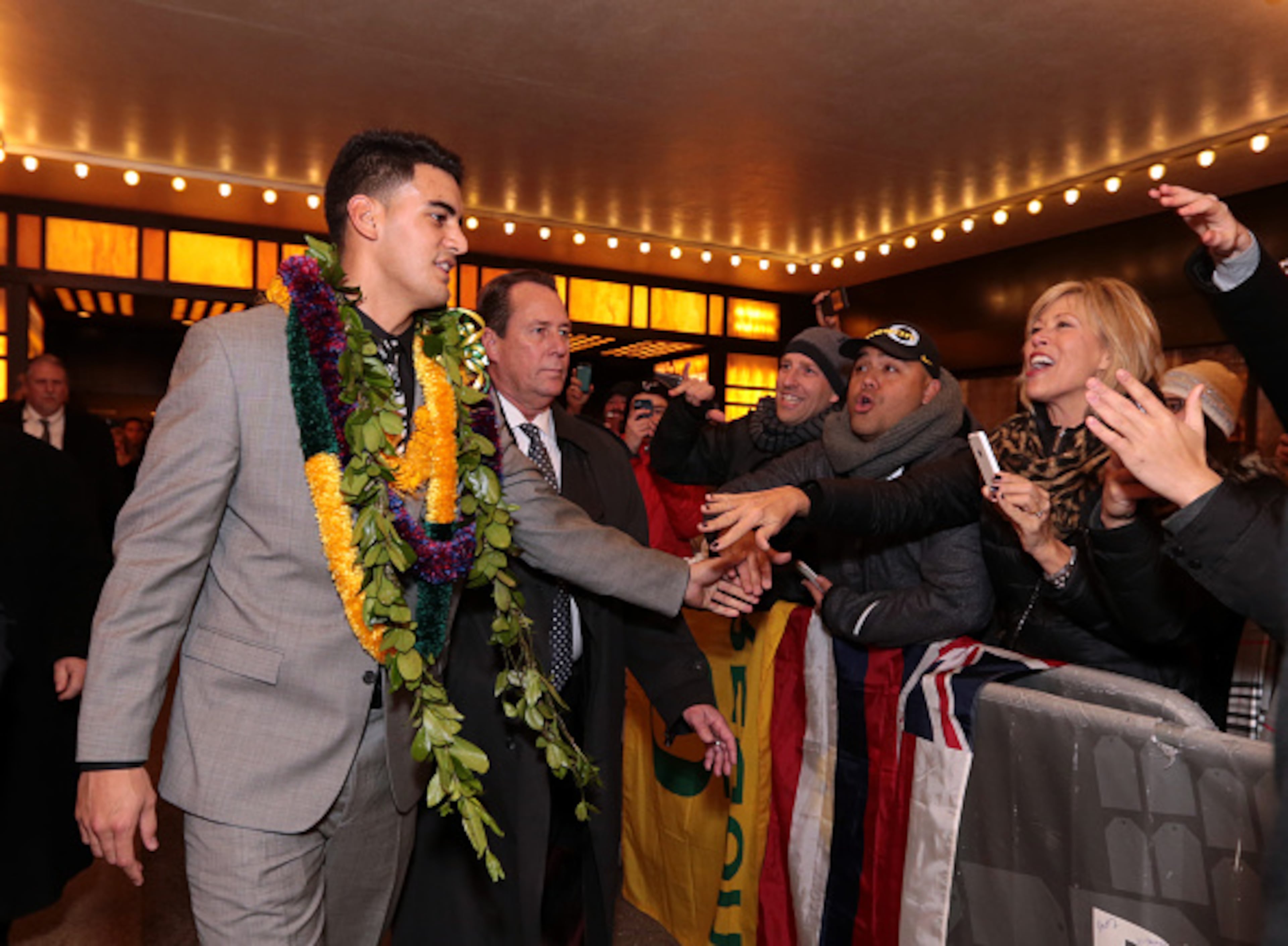 NEW YORK, NY - DECEMBER 13: Marcus Mariota, quarterback for the University of Oregon Ducks, shakes hands with fans after being named the 80th Heisman Memorial Trophy Award winner after the 2014 Heisman Trophy Presentation at the Best Buy Theater on December 13, 2014 in New York City. NOTE TO USER: Photographer approval needed for all Commercial License requests. (Photo by Kelly Kline/Getty Images for The Heisman)