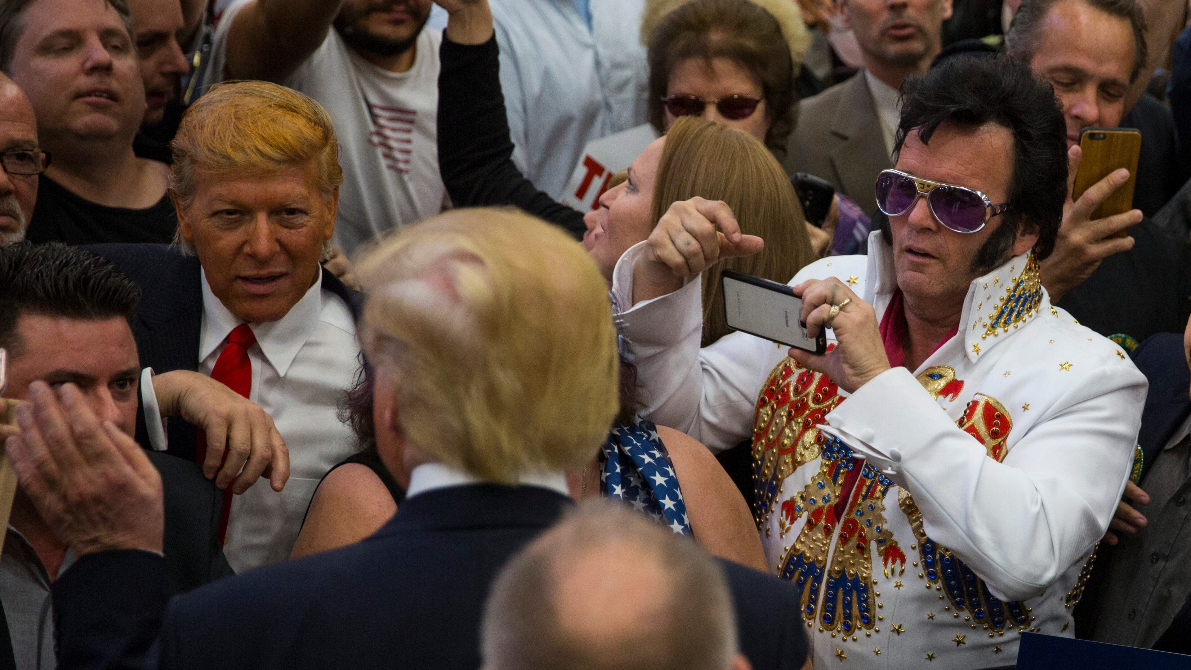 An attendee dressed in costume as Elvis takes photos of Donald Trump, a Republican presidential hopeful, as Trump greets the line after speaking at a campaign event at South Point Arena in Las Vegas, Feb. 22, 2016. (Ruth Fremson/The New York Times)