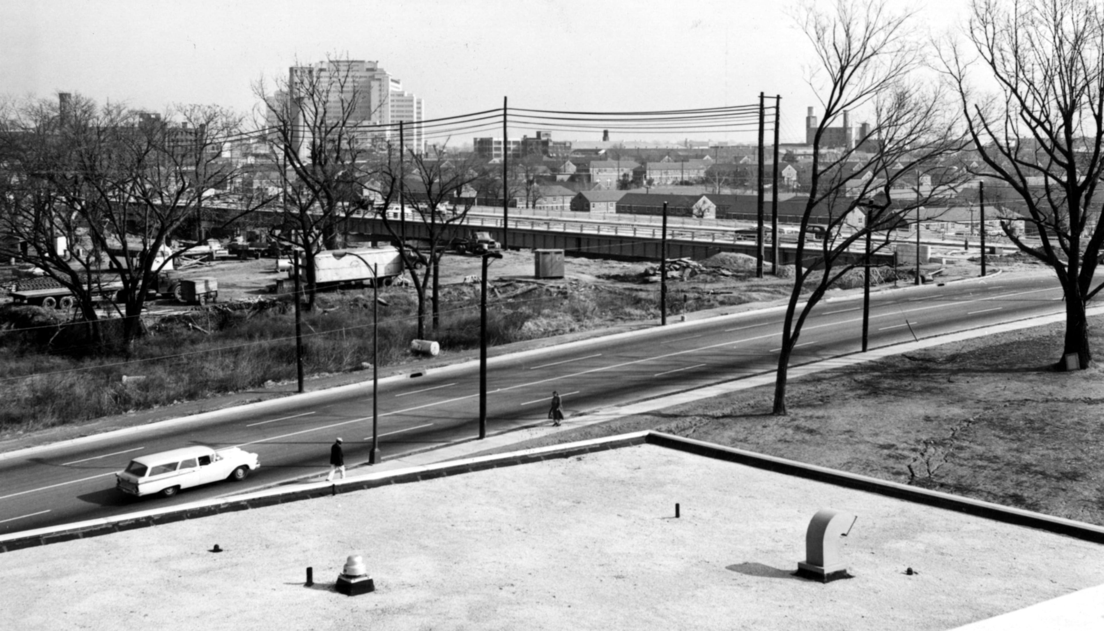 Feb. 1961 - Atlanta, Ga.: - (One of three photos) - This area will accommodate interchange of traffic flowing to and around Atlanta, which rears in skyline profile over branches of bare trees. (Area to become I-20 West) Capitol Avenue bridge is on right.