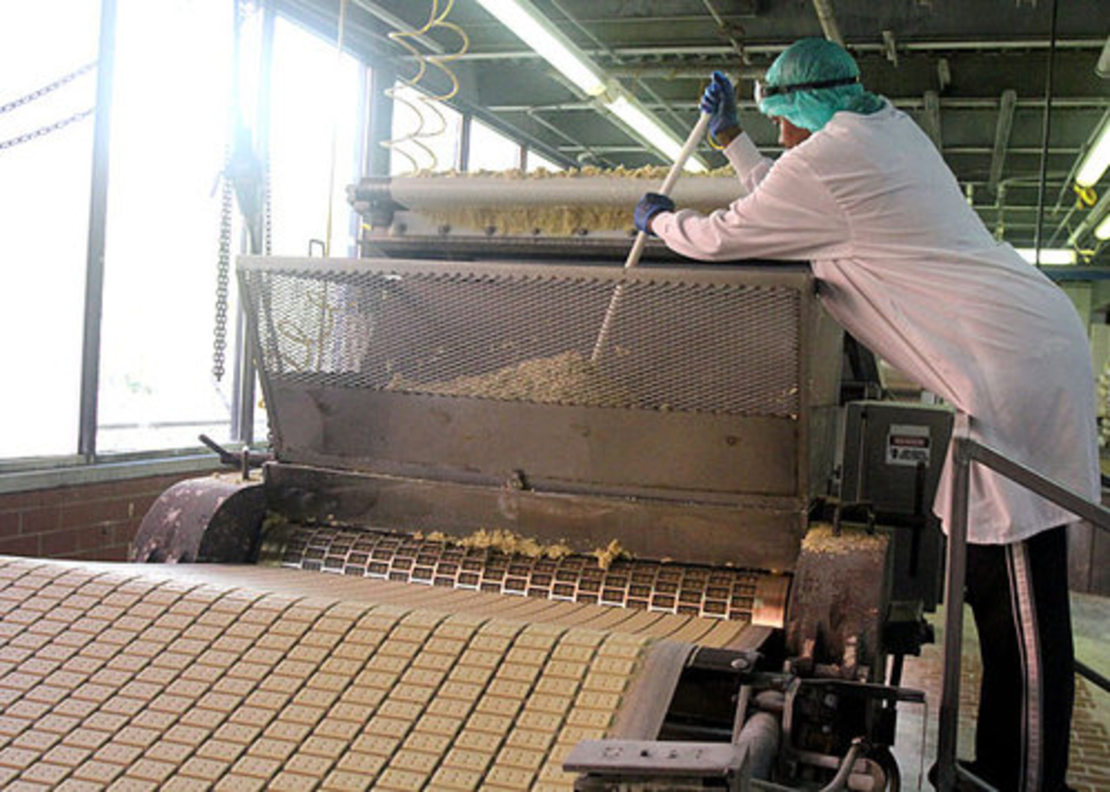 Cheryl Williams mixes the ingredients for brown vanilla wafers that will be formed & cooked by the thousands then crusted to make pie crust.