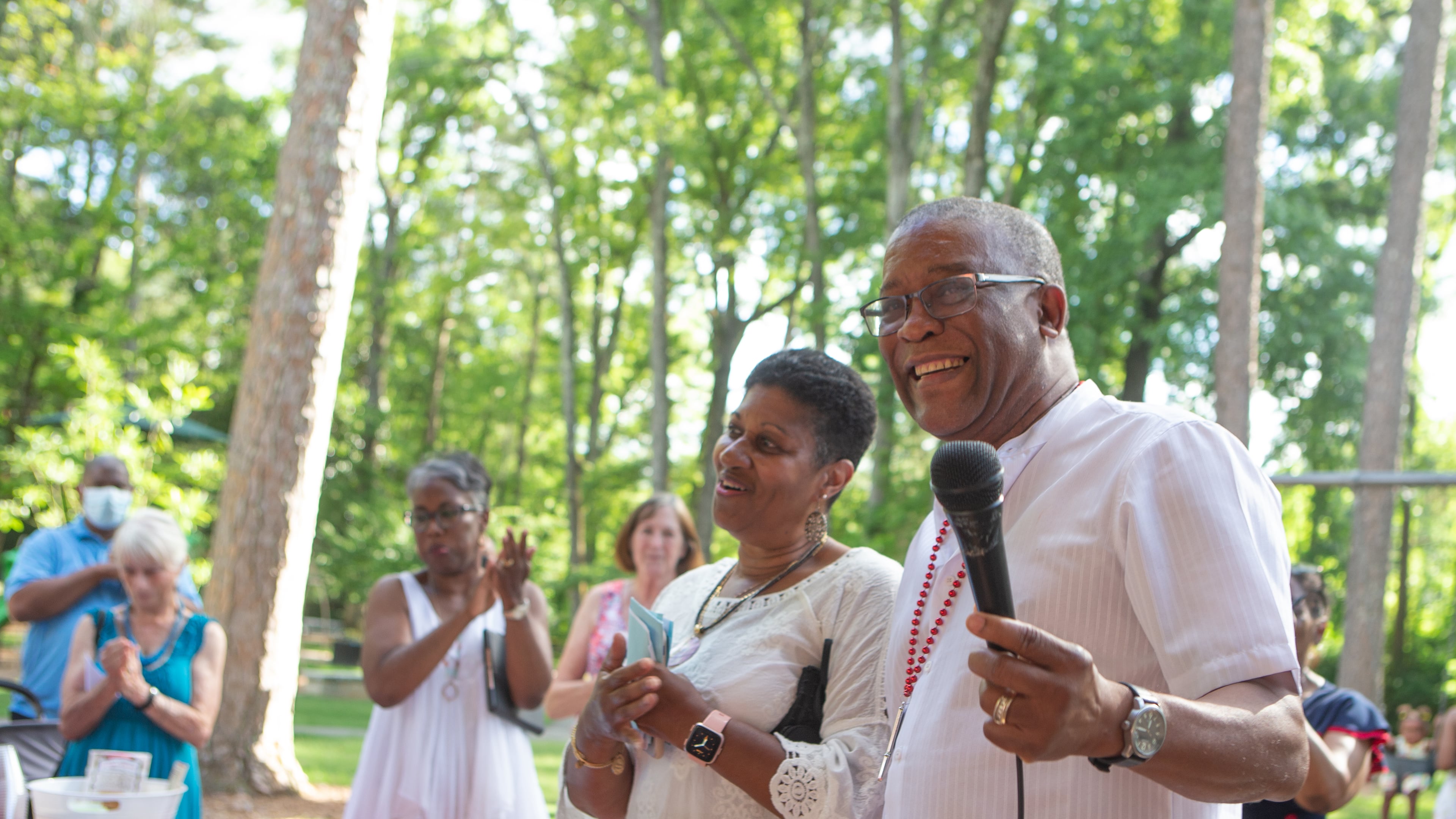 Avondale Estates postal clerk Russel Lewis (right) finishes speaking during his retirement party as his wife Cynthia Lewis (left) applauds. The Avondale community threw the gathering in honor of Lewis who served at the Avondale post office for 24 years. CHRISTINA MATACOTTA FOR THE ATLANTA JOURNAL-CONSTITUTION.