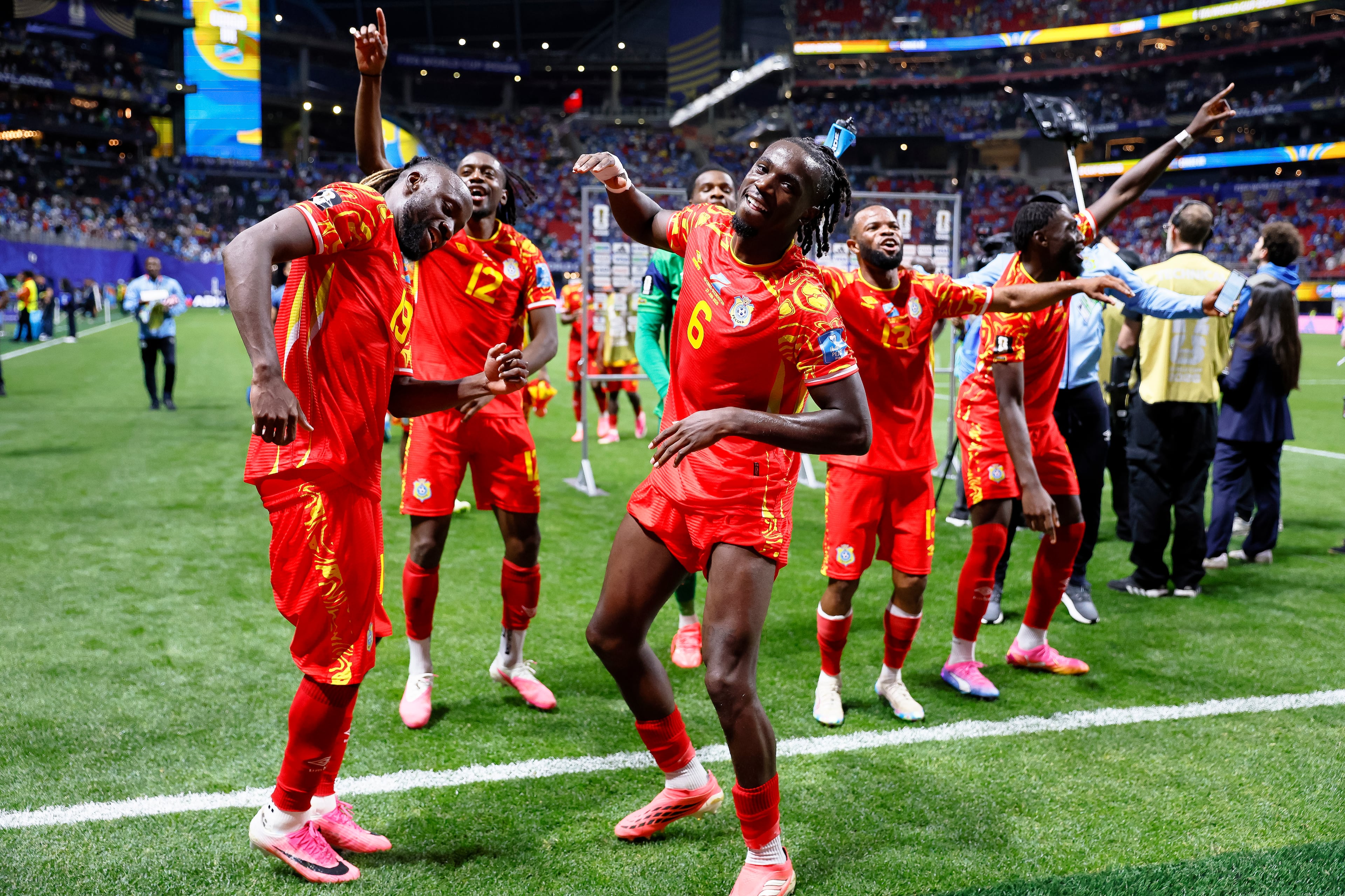 Congo midfielder Ngal'ayel Mukau (front right), forward Fiston Mayele (front left) and defender Joris Kayembe (back left) celebrate a 3-1 win over Uzbekistan after the second half of a FIFA World Cup match at Atlanta Stadium (Mercedes-Benz Stadium) on Saturday, June 27, 2026, in Atlanta. (Miguel Martinez/AJC)