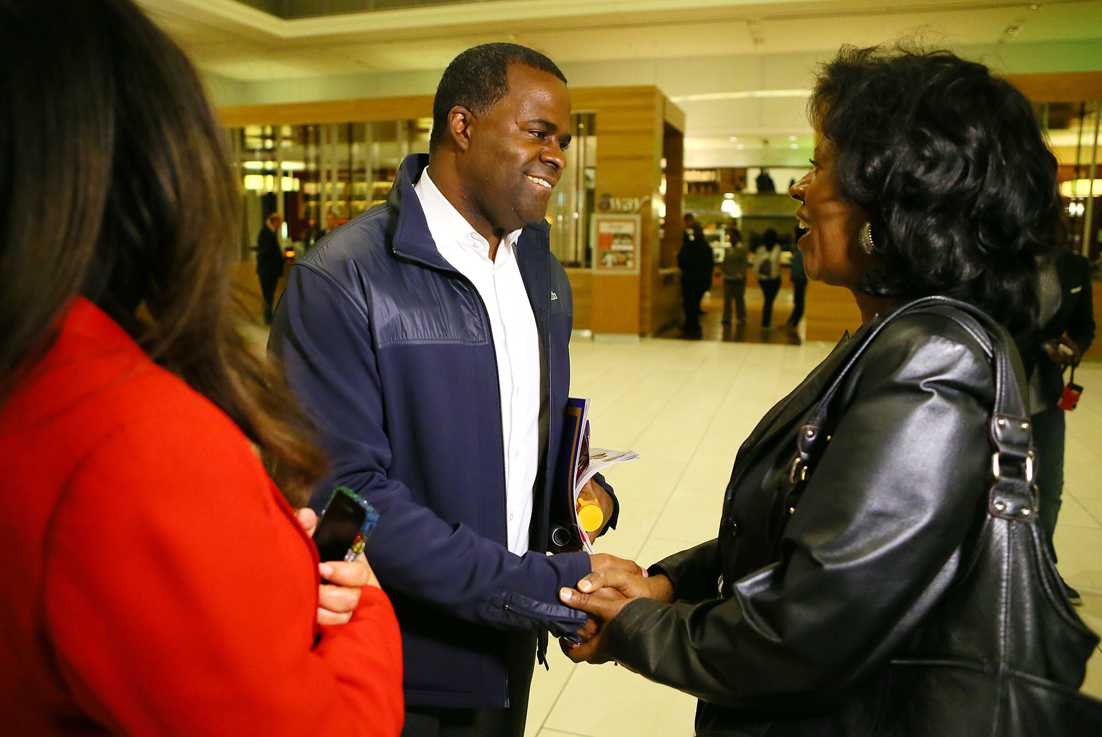 Atlanta Mayor Kasim Reed is greeted by supporters Karyn Harrison (left) and Darlene Ewing (right) in the lobby as he arrives at the Hyatt Regency where his election night celebration will take place on Tuesday, Nov. 5, 2013, in Atlanta. Reed said "I am ready to get to work. I am ready to work on infrastructure. This is my dream job."