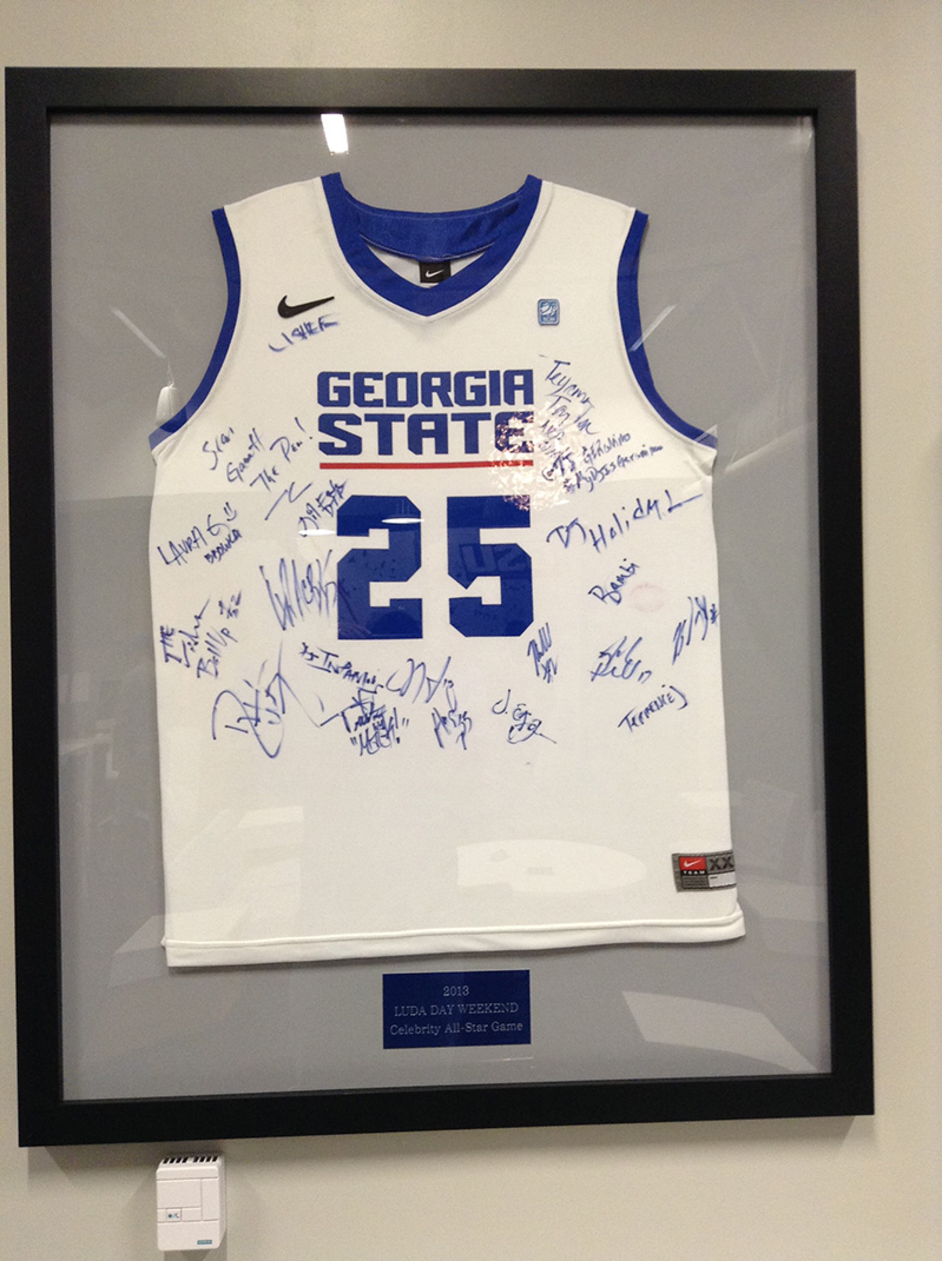 Signed memorabilia from rapper Ludacris' celebrity basketball tournament graces the walls.