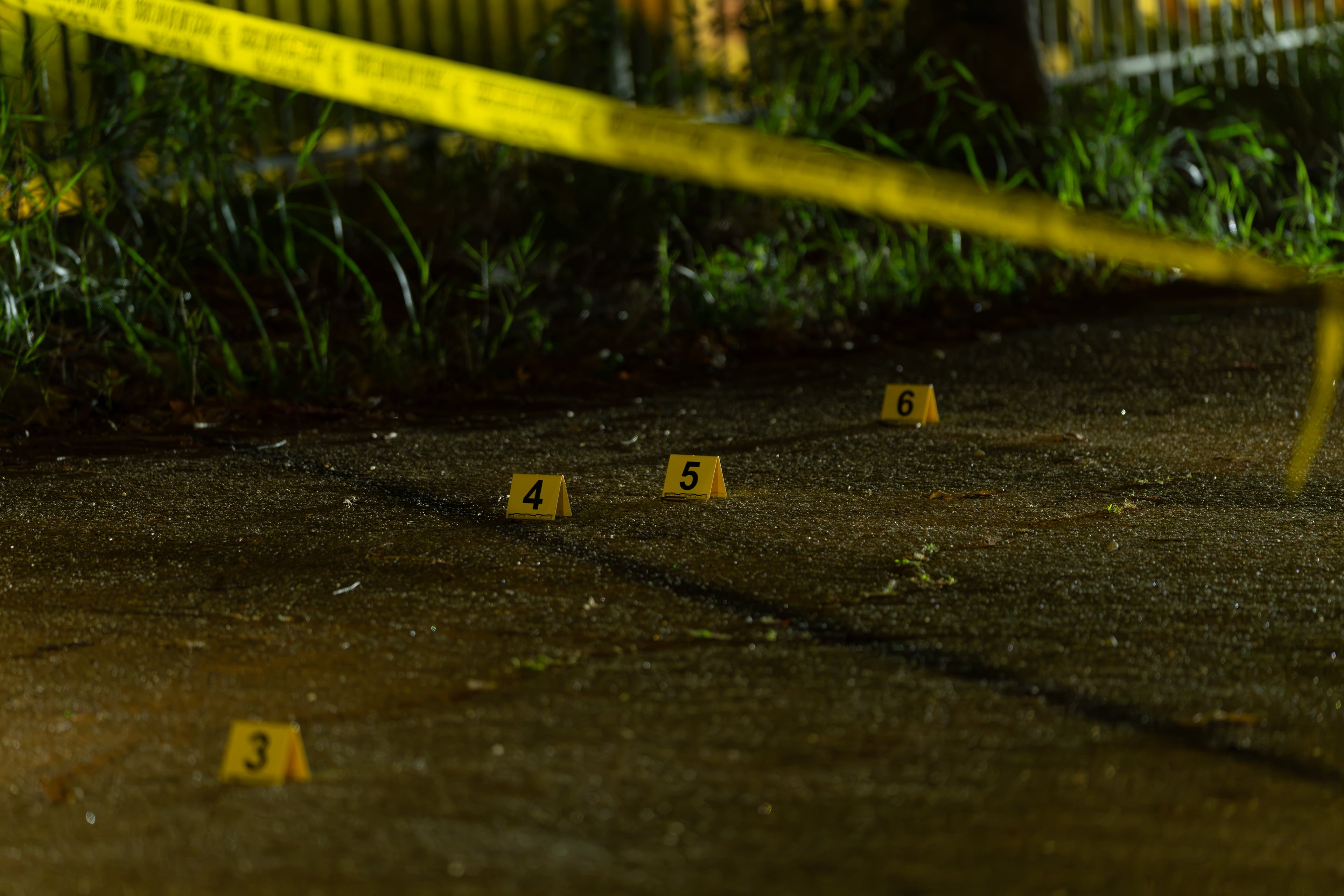 Shell casings sit next to evidence markers along Dunning Street on Saturday, Sept. 26, 2026, after a teenager was killed in a shooting late Friday. (Ben Hendren for the AJC)