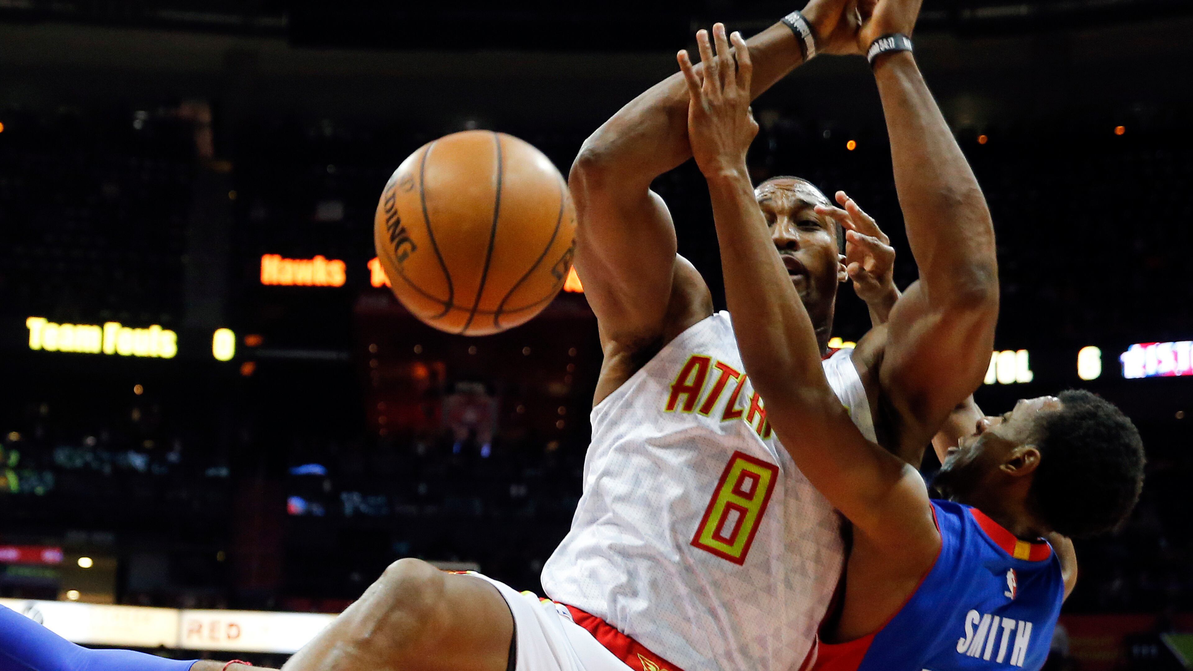 Atlanta Hawks center Dwight Howard (8) and Detroit Pistons guard Ish Smith (14) battle for a rebound in the first half of an NBA basketball game Friday, Dec. 2, 2016, in Atlanta. (AP Photo/John Bazemore)