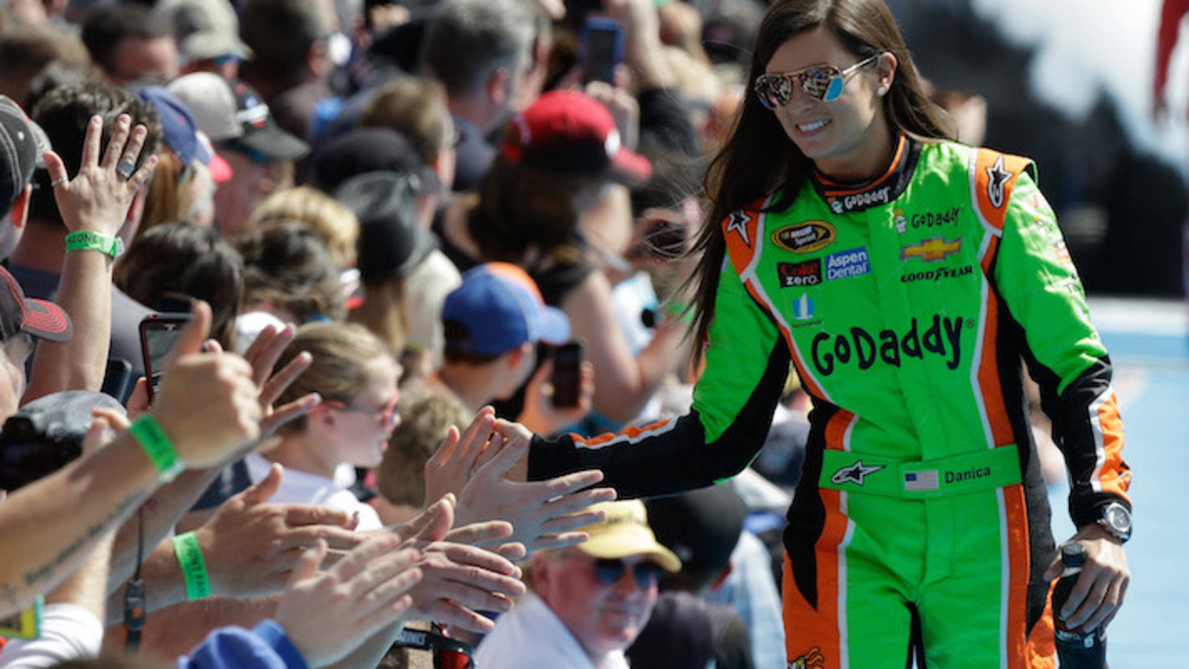 Danica Patrick greets fans as she is introduced before the start of the Daytona 500 NASCAR Sprint Cup series auto race at Daytona International Speedway in Daytona Beach, Fla., Sunday, Feb. 22, 2015. (AP Photo/John Raoux)