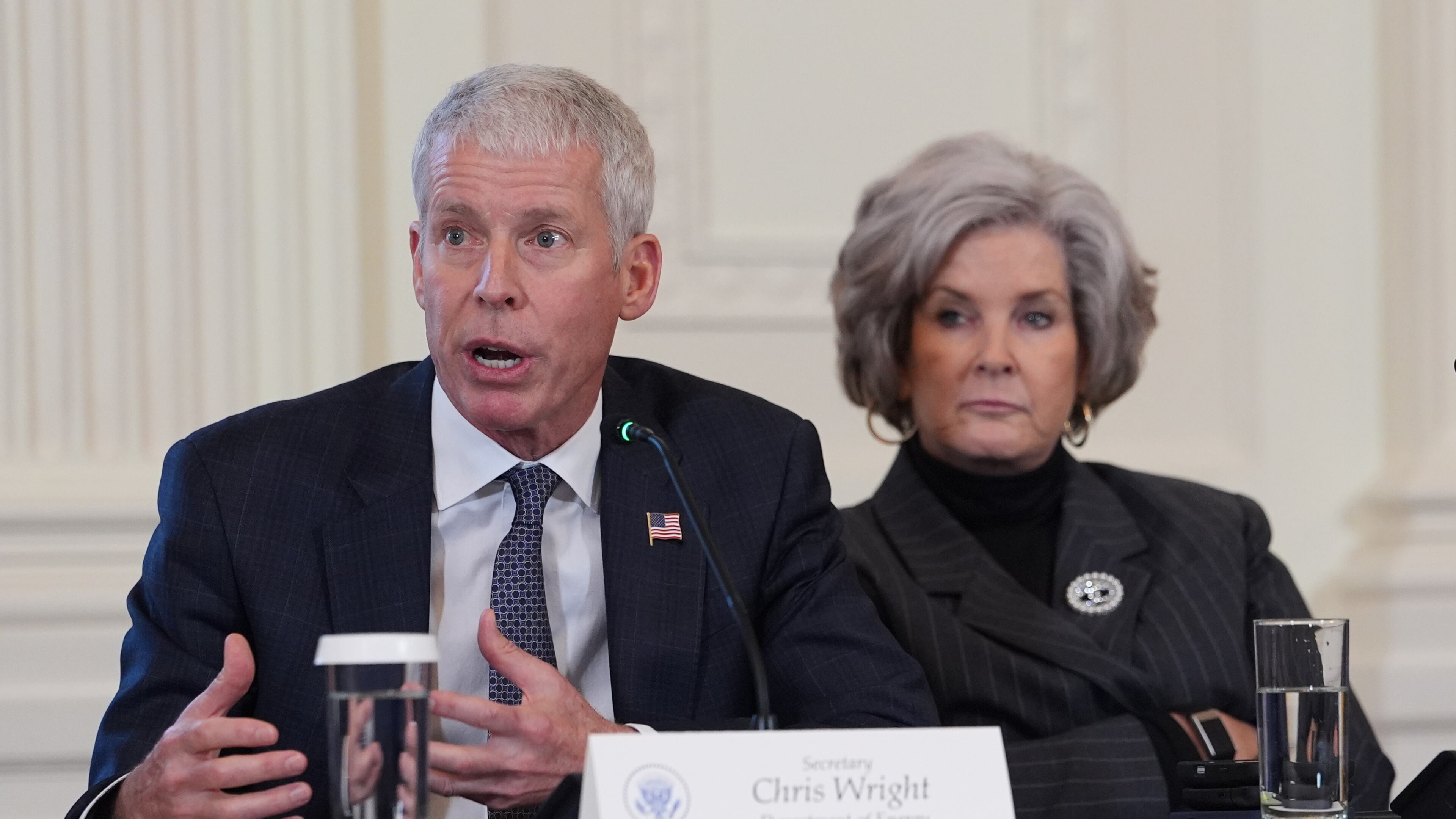 Energy Secretary Chris Wright speaks as White House chief of staff Susie Wiles listens during a meeting with President Donald Trump and oil executives in the East Room of the White House, Friday, Jan. 9, 2026, in Washington. (AP Photo/Evan Vucci)