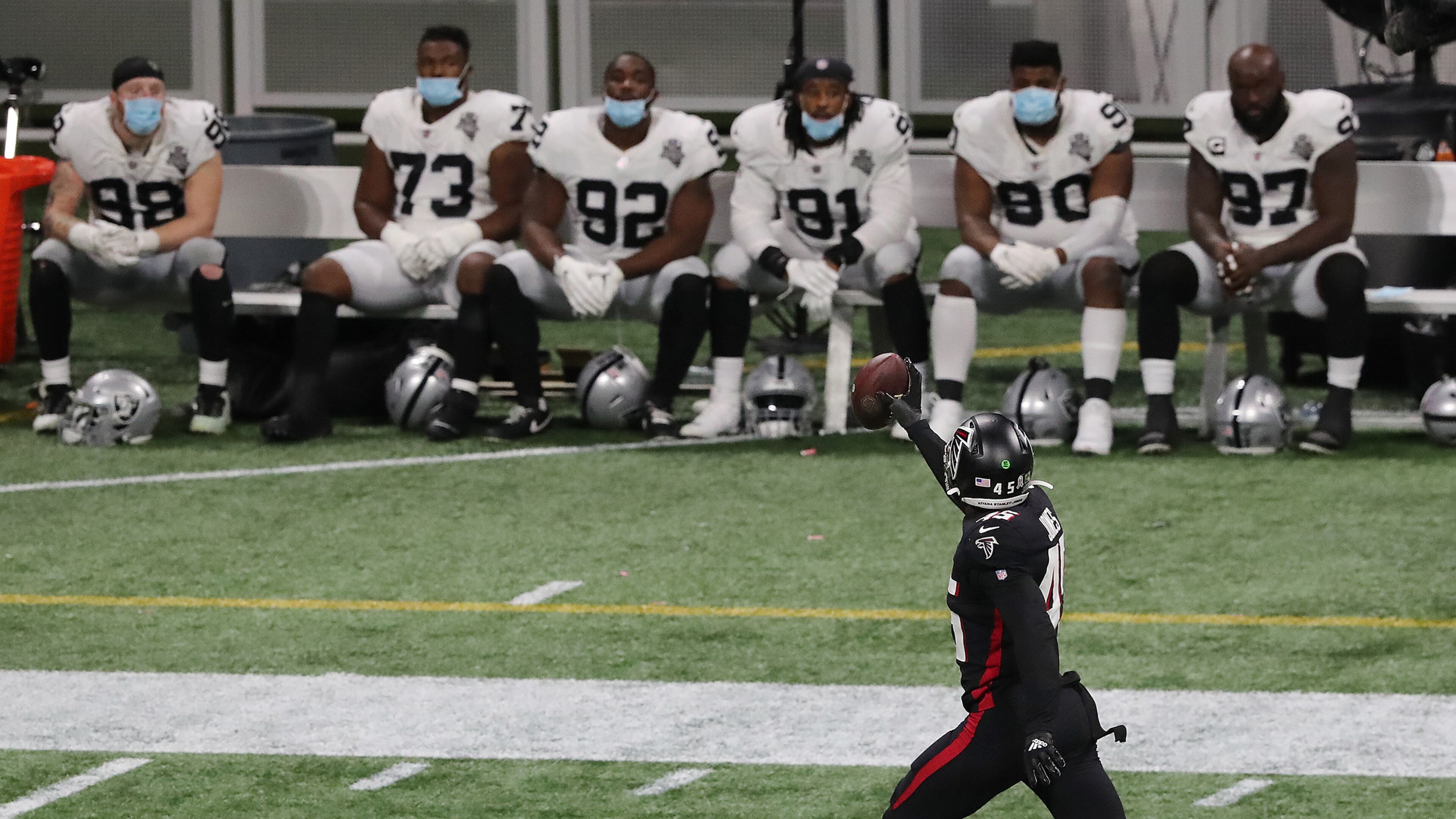 The Las Vegas Raiders' bench looks on as Atlanta Falcons linebacker Deion Jones intercepts a Derek Carr pass and returns it for a touchdown for a 23-3 lead during the third quarter on Sunday, Nov. 29, 2020, in Atlanta, Georgia. The Falcons beat the Raiders 43-6. (Curtis Compton/Atlanta Journal-Constitution/TNS)