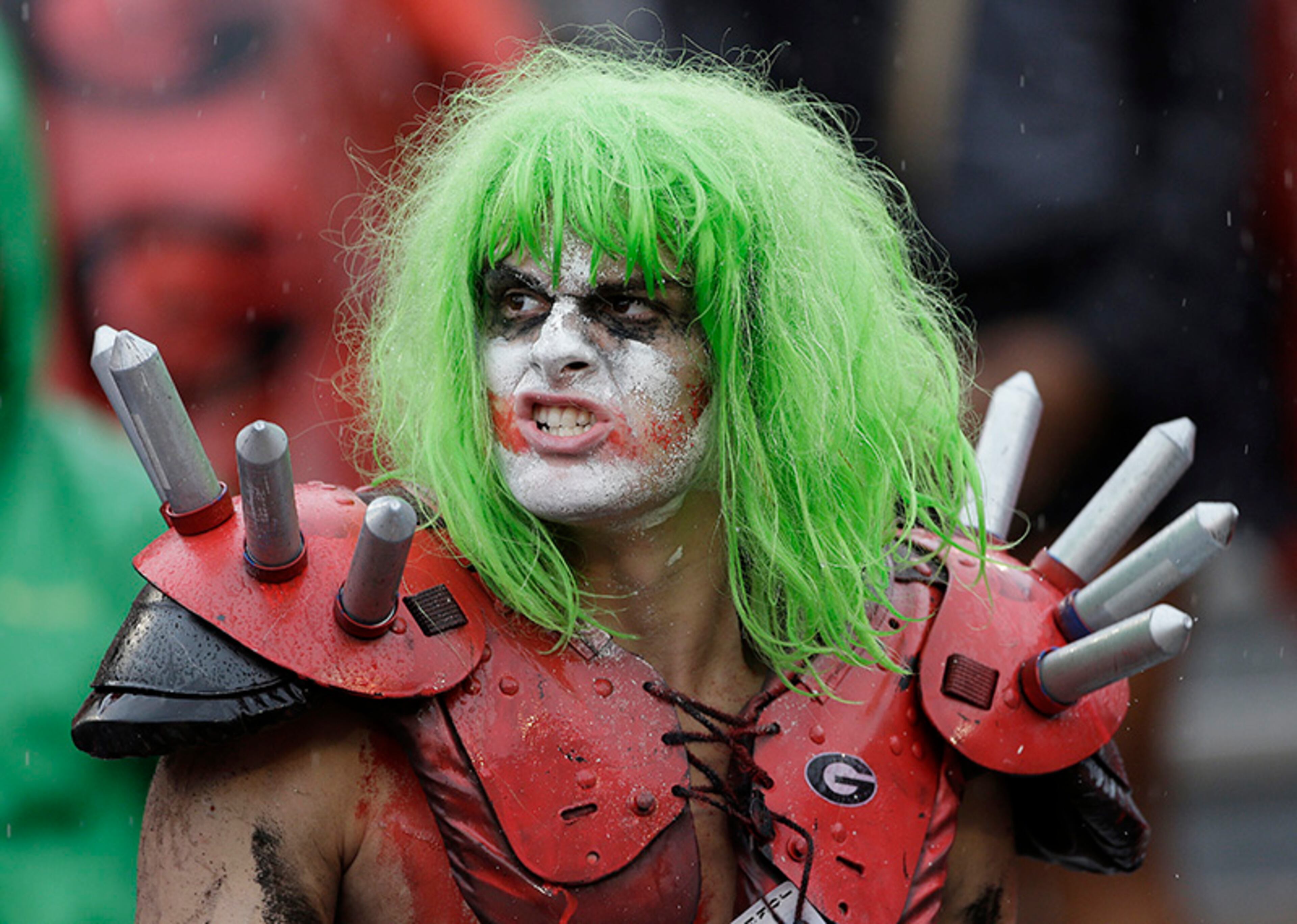 A Georgia painted fan watches in the rain in the second half of an NCAA college football game against the North Texas Saturday, Sept. 21, 2013 in Athens, Ga. Georgia won 45-21.