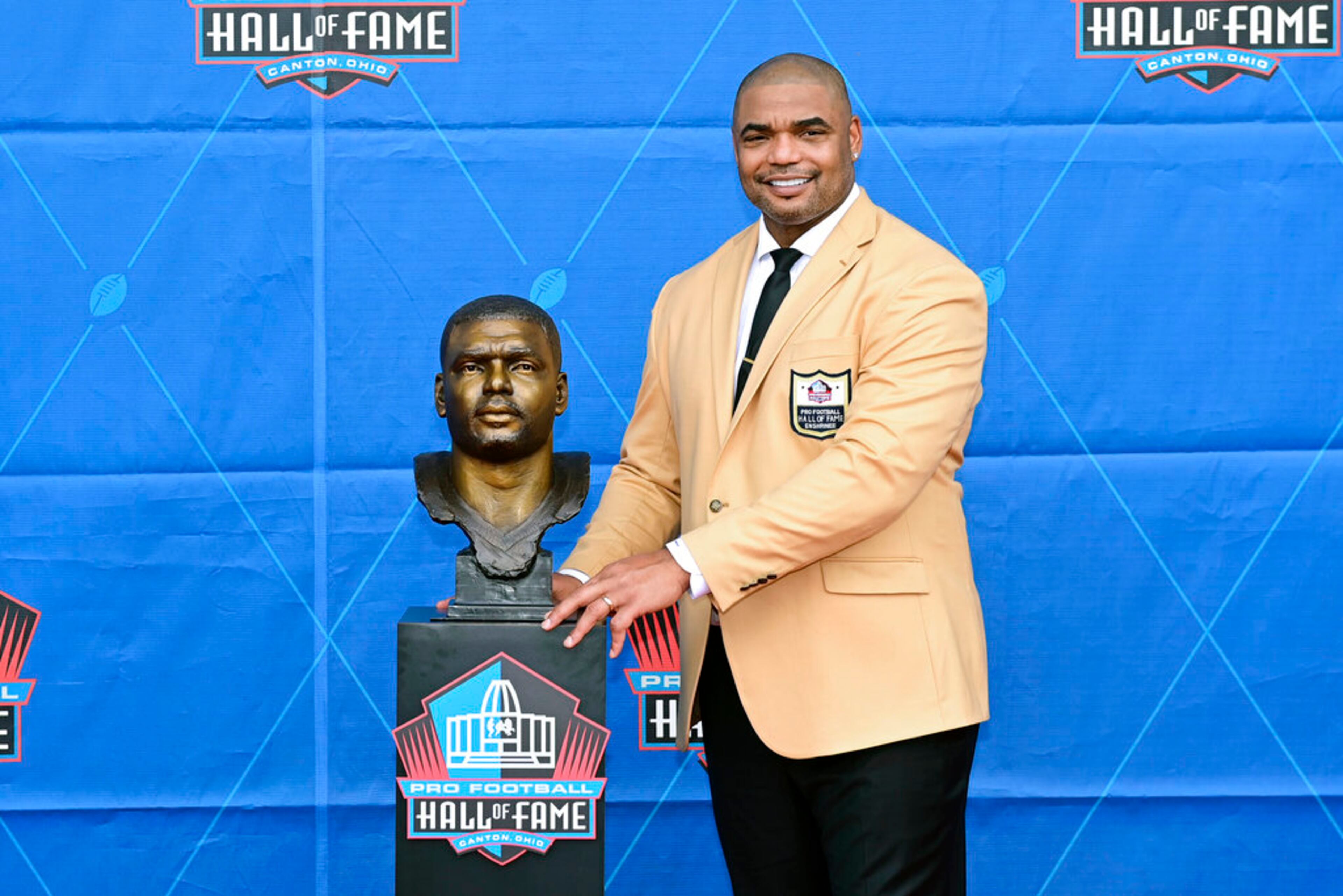 Former NFL player Richard Seymour poses with his bust during an induction ceremony at the Pro Football Hall of Fame in Canton, Ohio, Saturday, Aug. 6, 2022. (AP Photo/David Dermer)