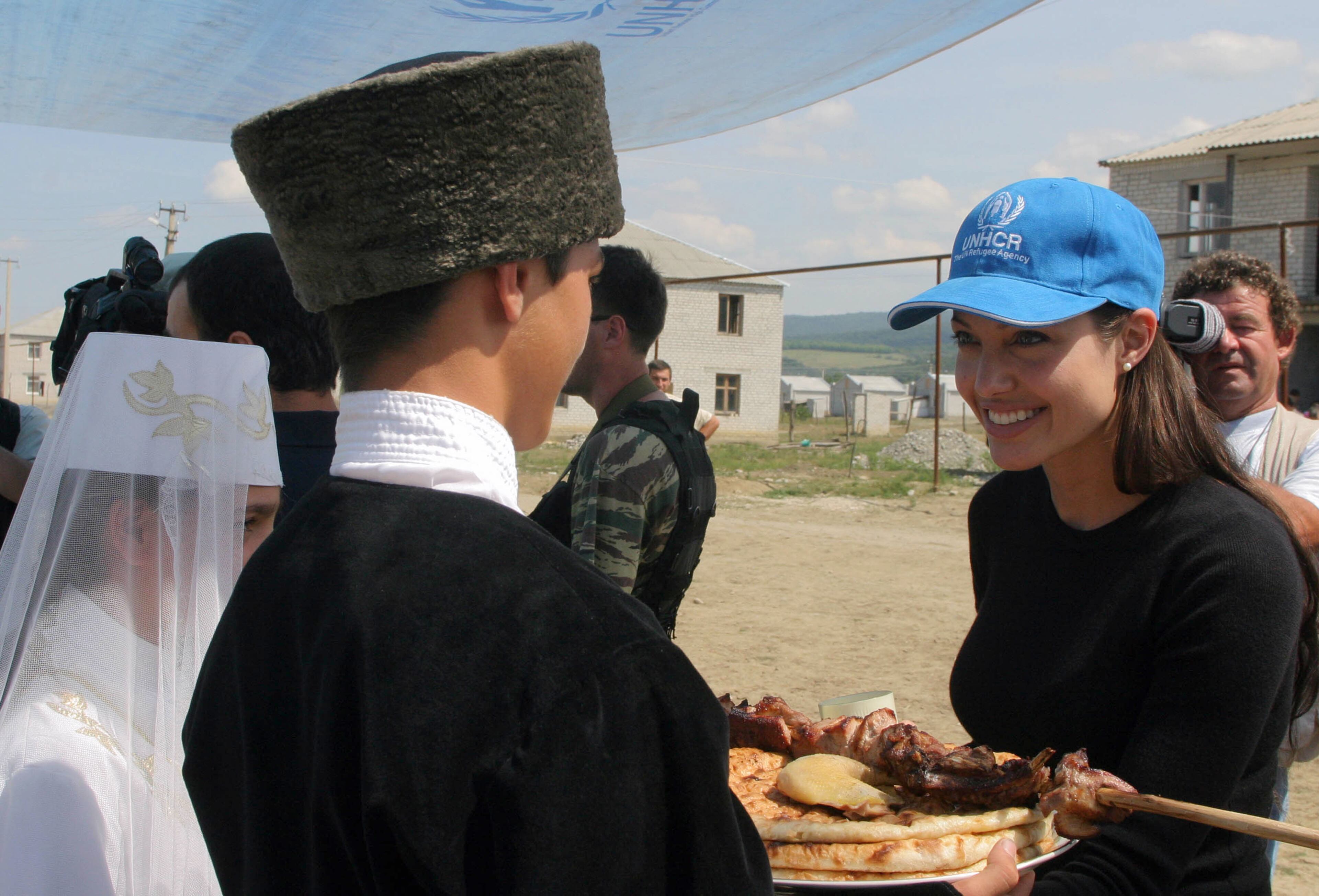 Actress Angelina Jolie walks thru a refugee camp August 23, 2003 near Vladikavkaz, Osetia. Jolie, who is in Russia as a goodwill ambassador for the UN High Commissioner for Refugees, visited refugee camps on August 22 in North Caucasus. (Photo by Getty Images)