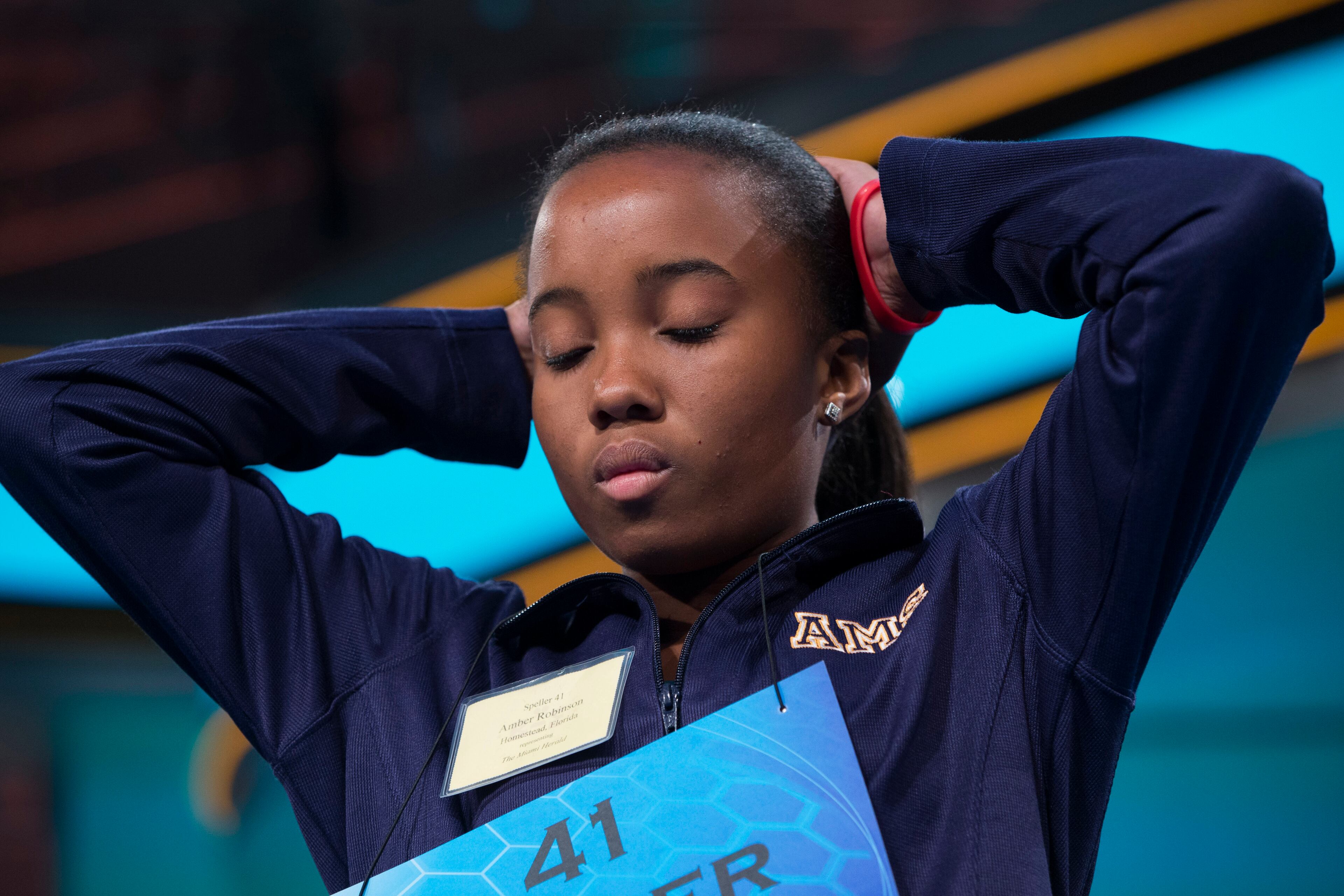 Amber Robinson of Homestead, Fla., concentrates before spelling the word "pelagial" incorrectly during the preliminary round of the National Spelling Bee, Wednesday, May 28, 2014, in Oxon Hill, Md. (AP Photo/ Evan Vucci)