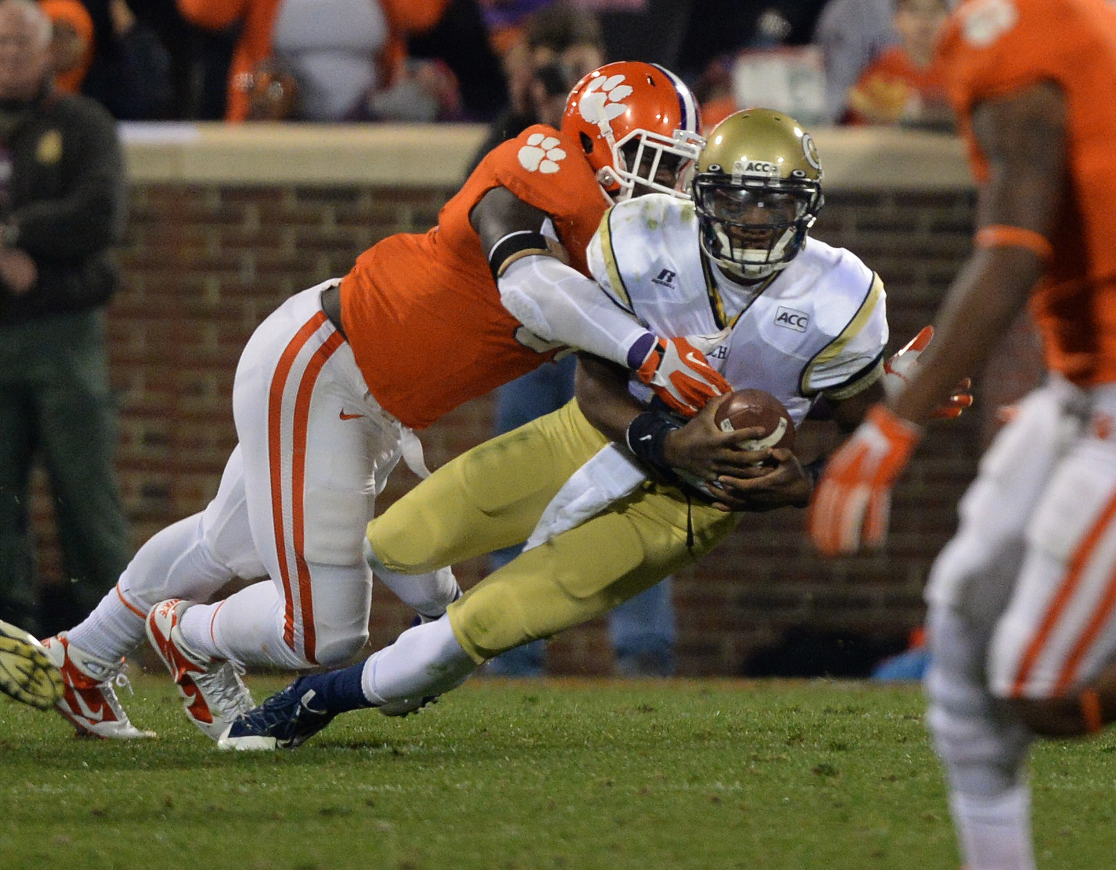 Georgia Tech's Vad Lee (2) is tackled by Clemson's Shaq Lawson (90) in the first quarter inside Clemson Memorial Stadium in Clemson, S.C.
