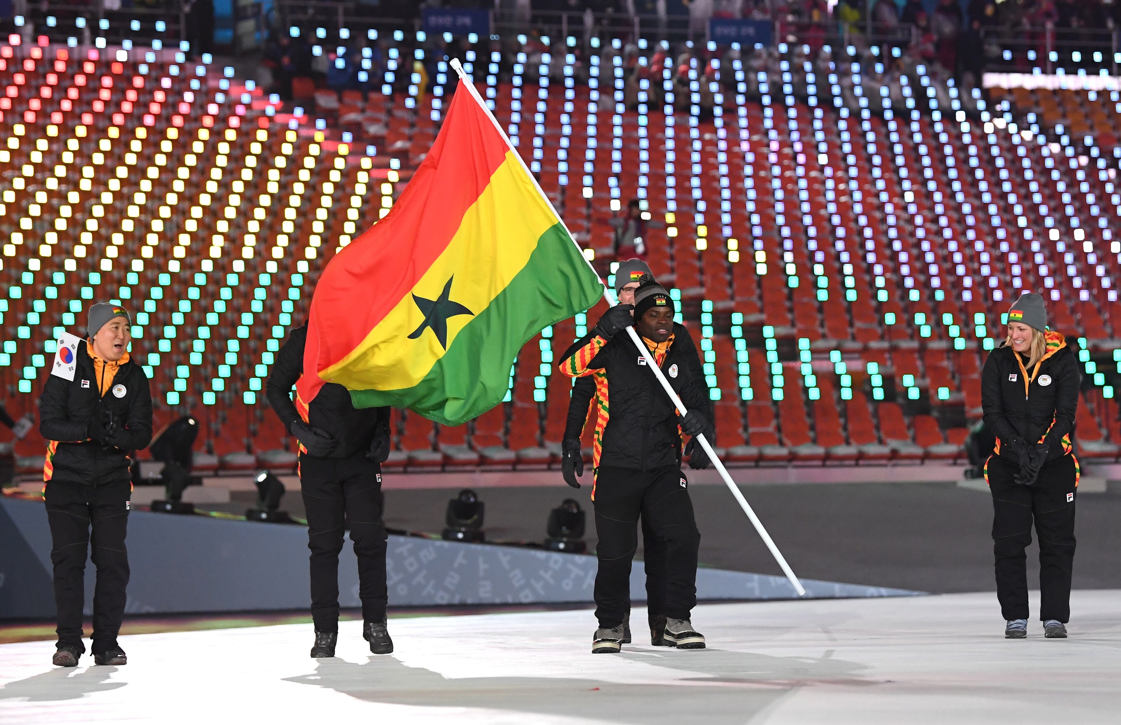 PYEONGCHANG-GUN, SOUTH KOREA - FEBRUARY 09: Flag bearer Akwasi Frimpong of Ghana and teammates enter the stadium during the Opening Ceremony of the PyeongChang 2018 Winter Olympic Games at PyeongChang Olympic Stadium on February 9, 2018 in Pyeongchang-gun, South Korea. (Photo by Matthias Hangst/Getty Images)