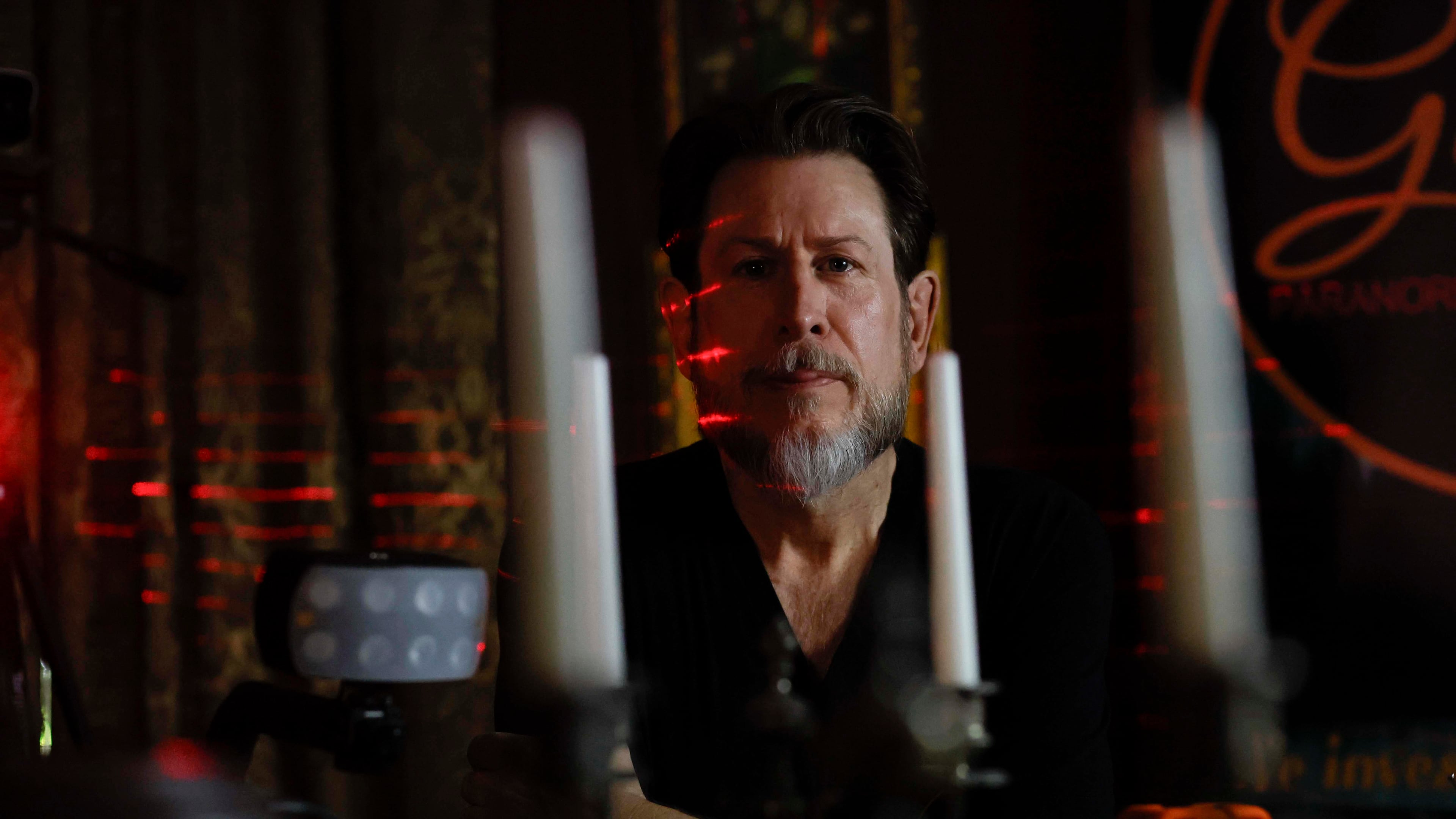 Paranormal investigator Philip Wyatt posed for a photograph in his home on Tuesday, Oct. 13, 2025. He has been investigating paranormal events for 15 years, a pursuit that began after personal experiences sparked his interest. (Miguel Martinez/AJC)