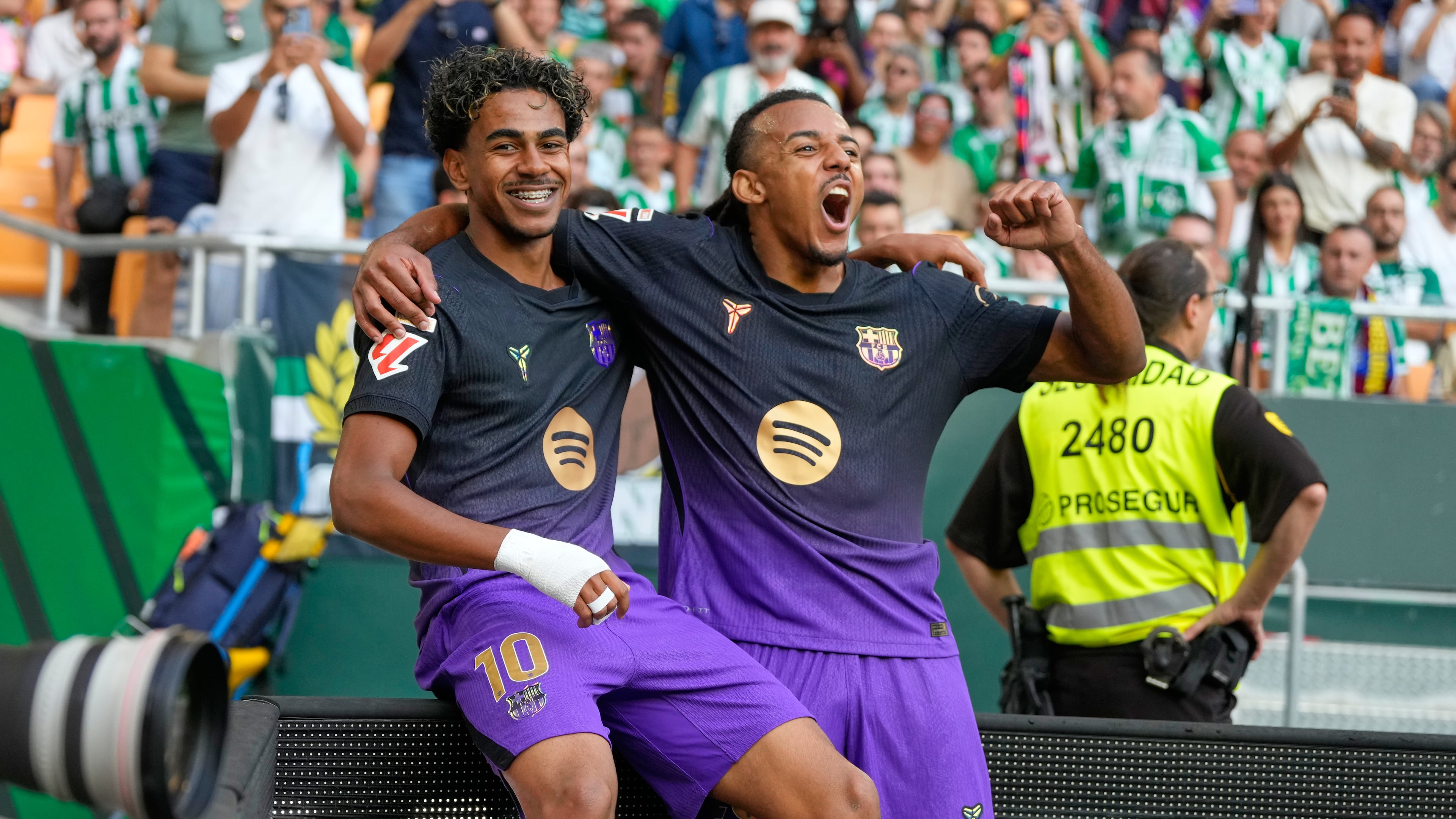 Barcelona's Lamine Yamal, left, celebrates with Barcelona's Jules Kounde after scoring his side's opening goal during the Spanish La Liga soccer match between Real Betis and Barcelona in Seville, Spain, Saturday, Oct. 17, 2026. (AP Photo/Jose Breton)