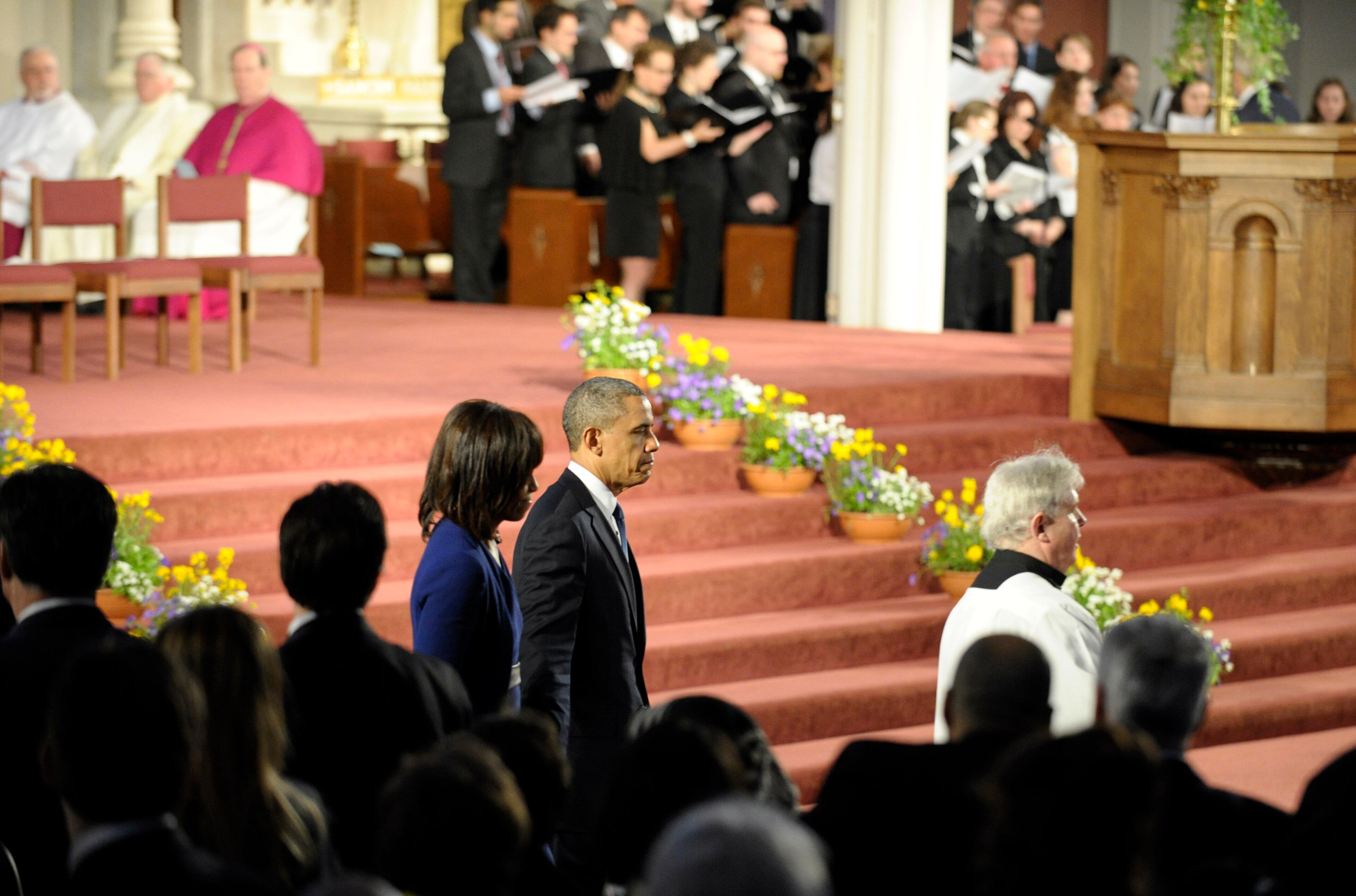 President Barack Obama and first lady Michelle Obama arrive to attend the "Healing Our City: An Interfaith Service" at the Cathedral of the Holy Cross in Boston.
