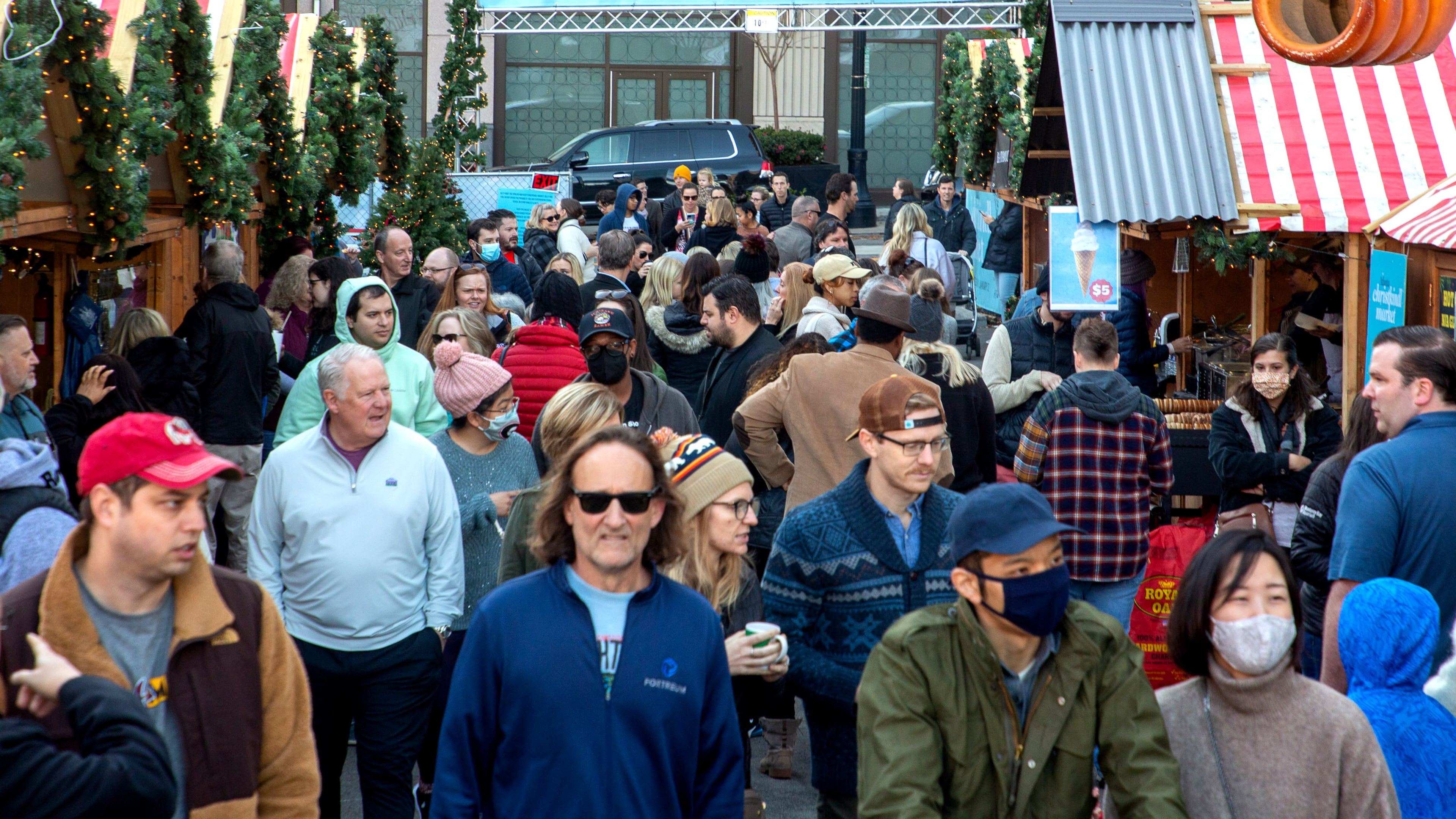 People walk past the food and vendors at the Atlanta Christkindl Market on Sunday, December 12, 2021. STEVE SCHAEFER FOR THE ATLANTA JOURNAL-CONSTITUTION