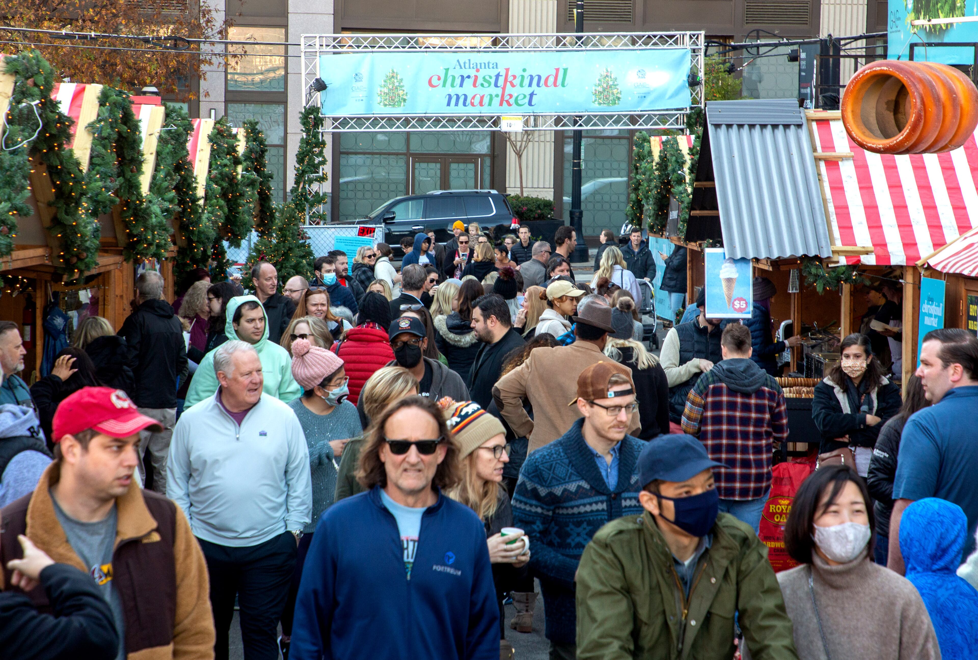 People walk past the food and vendors at the Atlanta Christkindl Market on Sunday, December 12, 2021. STEVE SCHAEFER FOR THE ATLANTA JOURNAL-CONSTITUTION
