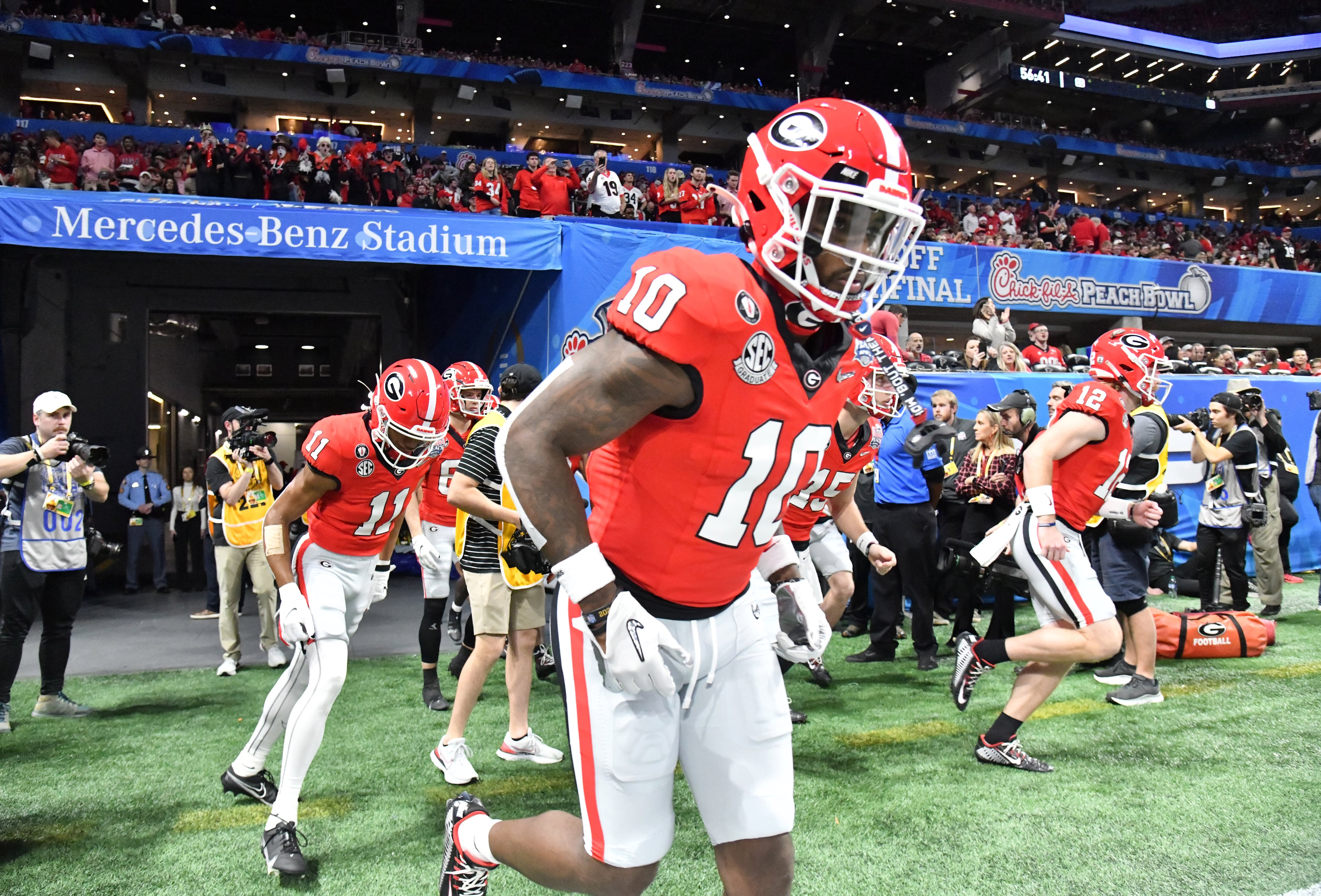 Georgia players run onto the football field before the 2022 CFP Semifinal between Georgia and Ohio State at the Chick-fil-A Peach Bowl Saturday, Dec. 31, 2022, in Atlanta. (Hyosub Shin / Hyosub.Shin@ajc.com)