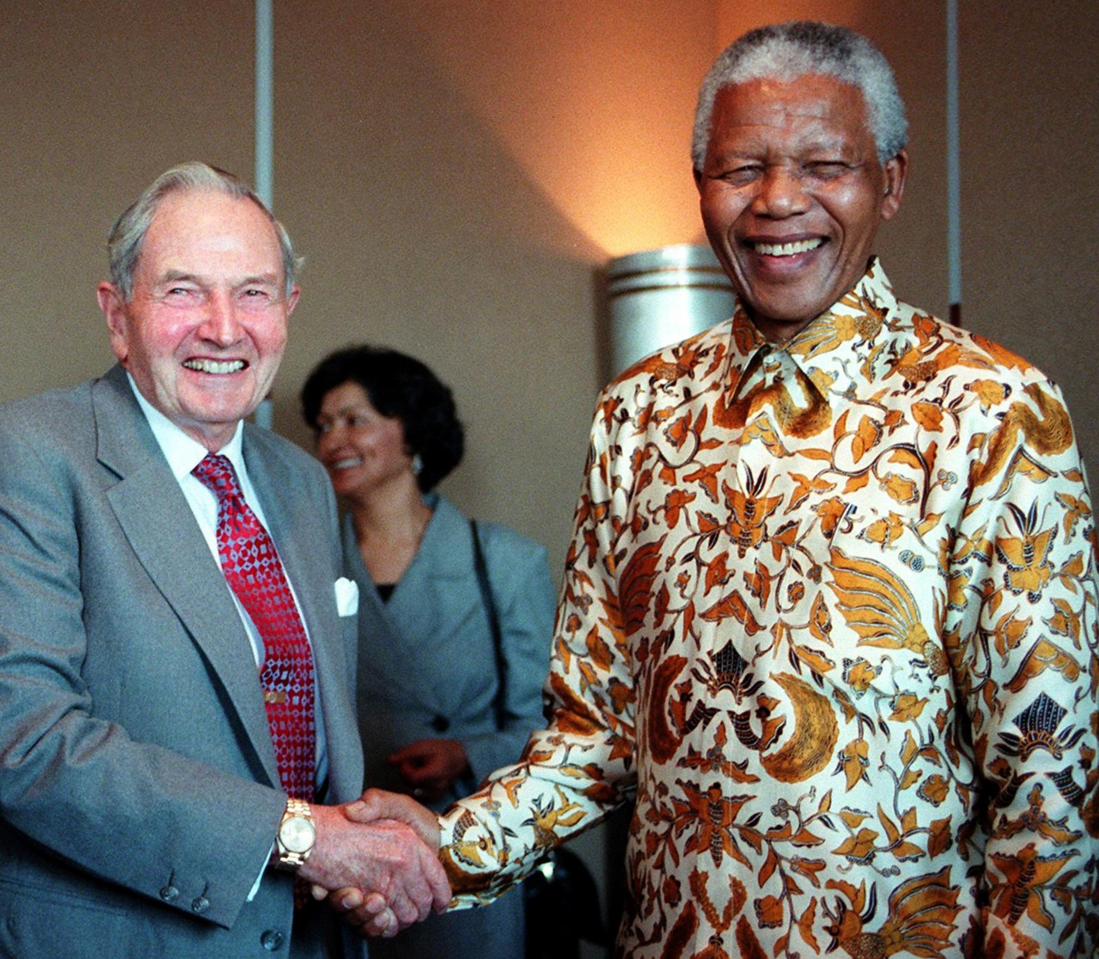 NEW YORK, UNITED STATES: President Nelson Mandela (R) of South Africa shakes hands with David Rockefeller (L) after a press conference during which Mandela discussed his breakfast meeting with business leaders in Rockefeller Center in New York 18 September. AFP PHOTO Henny Ray ABRAMS (Photo credit should read HENNY RAY ABRAMS/AFP/Getty Images)