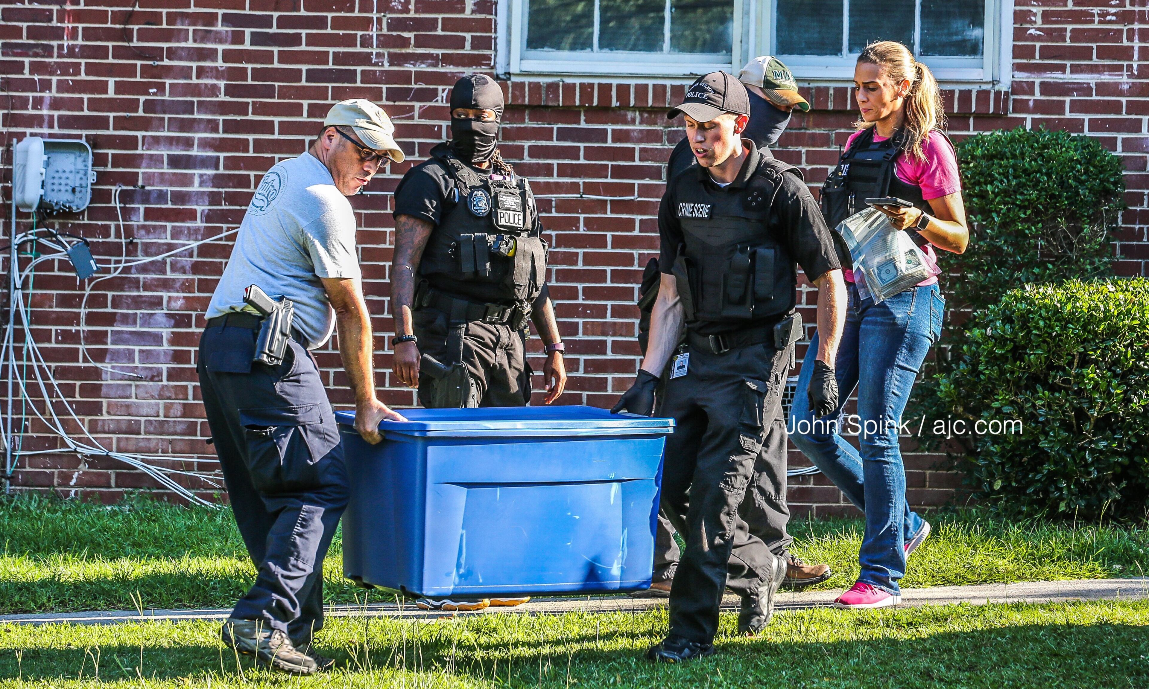 The South Fulton police narcotics unit carries out equipment and suspected drugs from a home on Ocean Valley Road on Friday morning.