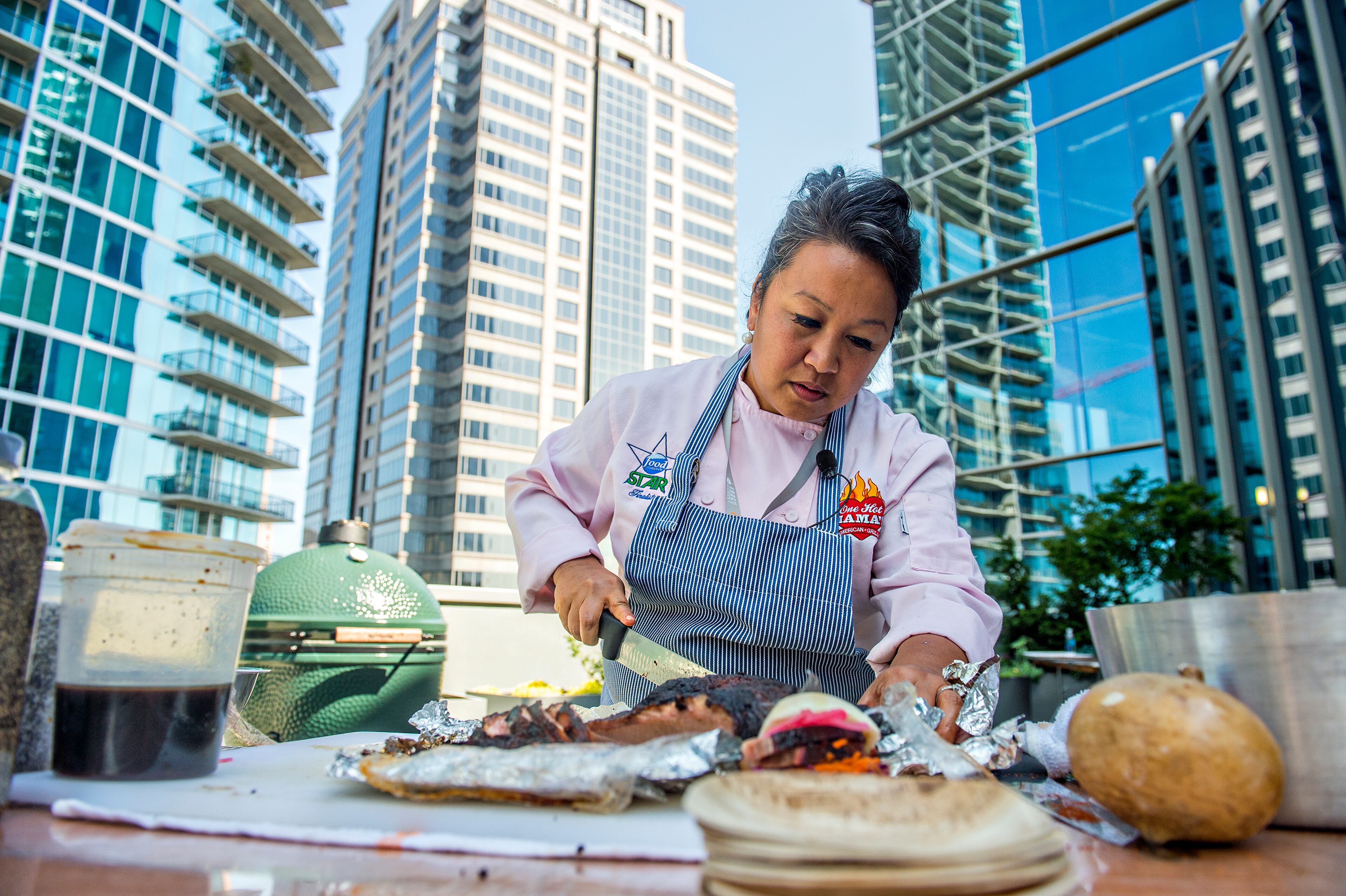 May 30, 2015 Atlanta - Chef Orchid Paulmeier (left) slices brisket during the Atlanta Food & Wine Festival at Loews Atlanta Hotel in Midtown on Saturday, May 30, 2015. Thousands of people tasted food and beverages prepared by chefs, brewers, distillers, wine makers and cocktail connoisseurs from all over the country. JONATHAN PHILLIPS / SPECIAL