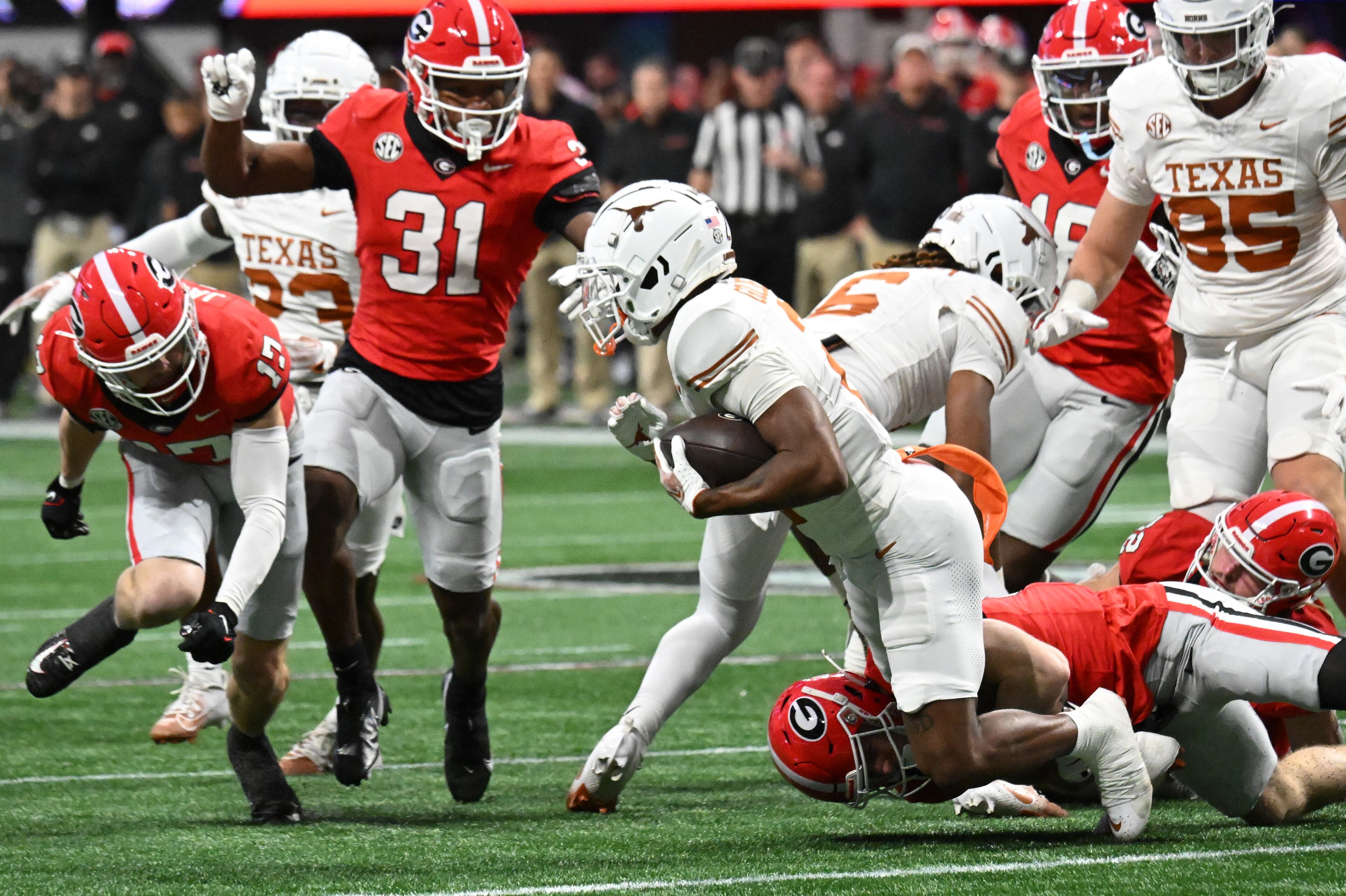 Texas wide receiver Matthew Golden (2) gets tackled from behind by Georgia wide receiver Cole Speer (83) during the SEC Championship football game at the Mercedes-Benz Stadium, Saturday, December 7, 2024, in Atlanta. (Hyosub Shin / AJC)