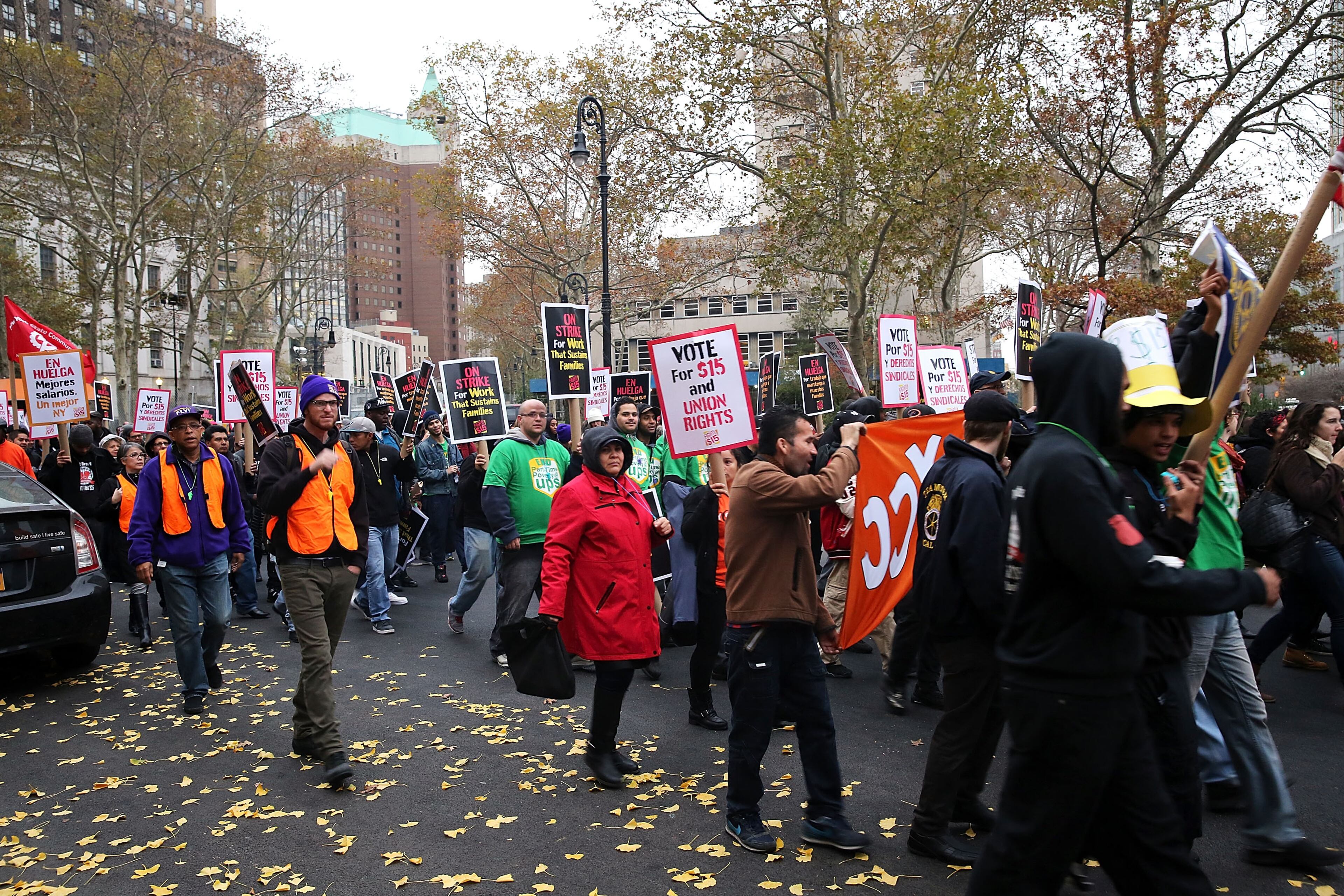 NEW YORK, NY - NOVEMBER 10: Low wage workers and supporters protest for a $15 an hour minimum wage on November 10, 2015 in New York, United States. In what organizers are calling a National Day of Action for $15 and hour minimum wage, thousands of people took to the streets across the country to stage protests in front of businesses that are paying some of their workers the minimum wage. Home care workers, employees in retail and fast food restaurants say that the current minimum is not a living wage. (Photo by Spencer Platt/Getty Images)