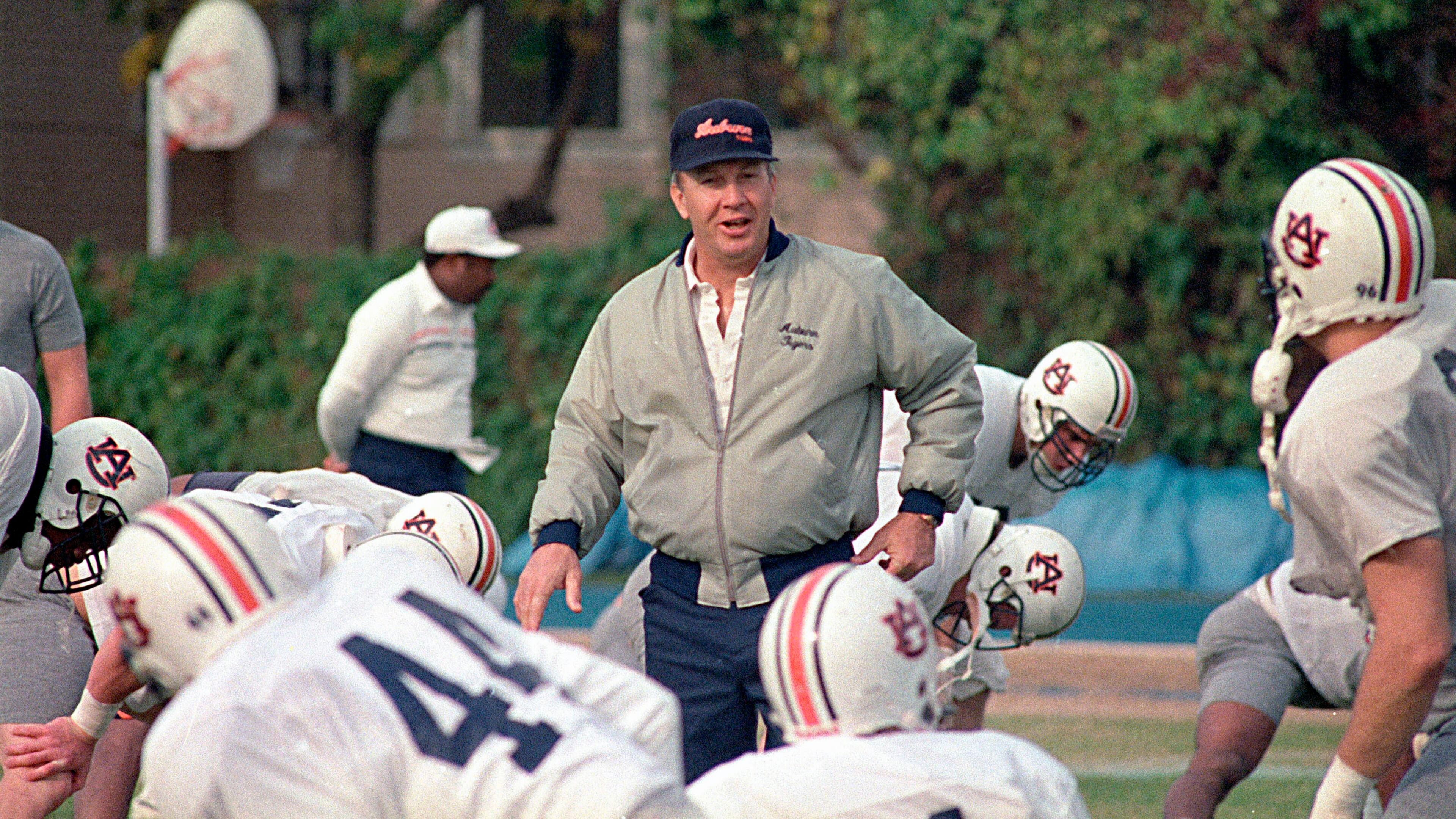 FILE - In this Dec. 27, 1988, file photo, Auburn football coach Pat Dye walks through his players as they begin workouts in preparation for the Sugar Bowl in New Orleans. Former Auburn coach Pat Dye, who took over a downtrodden football program in 1981 and turned it into a Southeastern Conference power, has died. He was 80. Lee County Coroner Bill Harris said Dye passed away Monday, June 1, 2020, at the Compassus Bethany House in Auburn, Ala.(AP Photo/Bill Haber, FIle)
