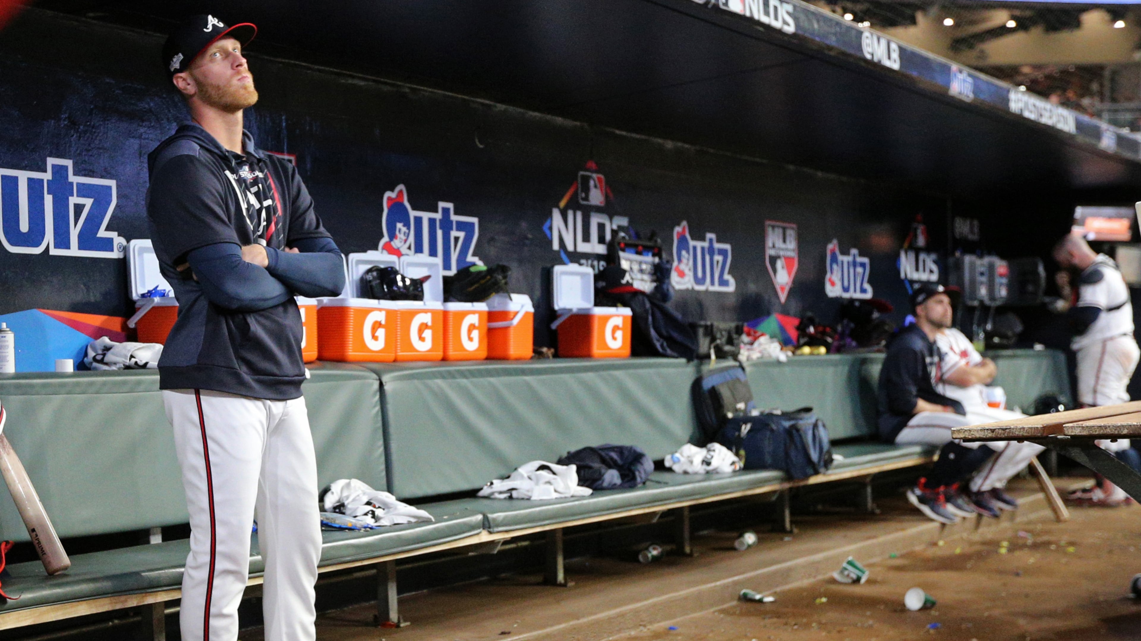 Mike Foltynewicz stands alone in the dugout following his implosion in Game 5 of the 2018 NLDS. (Curtis Compton/AJC)