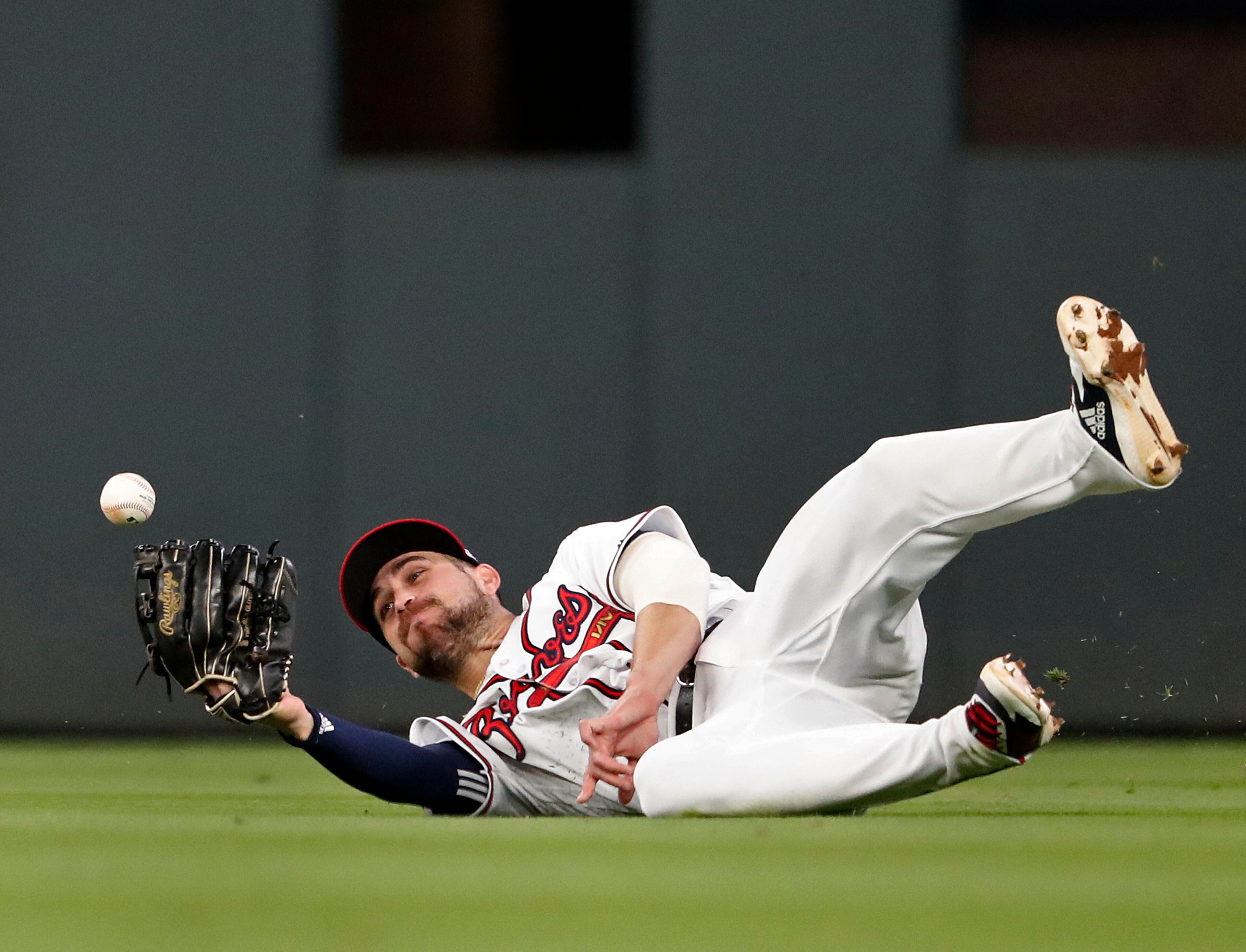 A ball hit for an RBI-single by Arizona Diamondbacks' Nick Ahmed gets away from Atlanta Braves center fielder Ender Inciarte (11) in the fourth inning of a baseball game, Tuesday, April 16, 2019, in Atlanta. (AP Photo/John Bazemore)