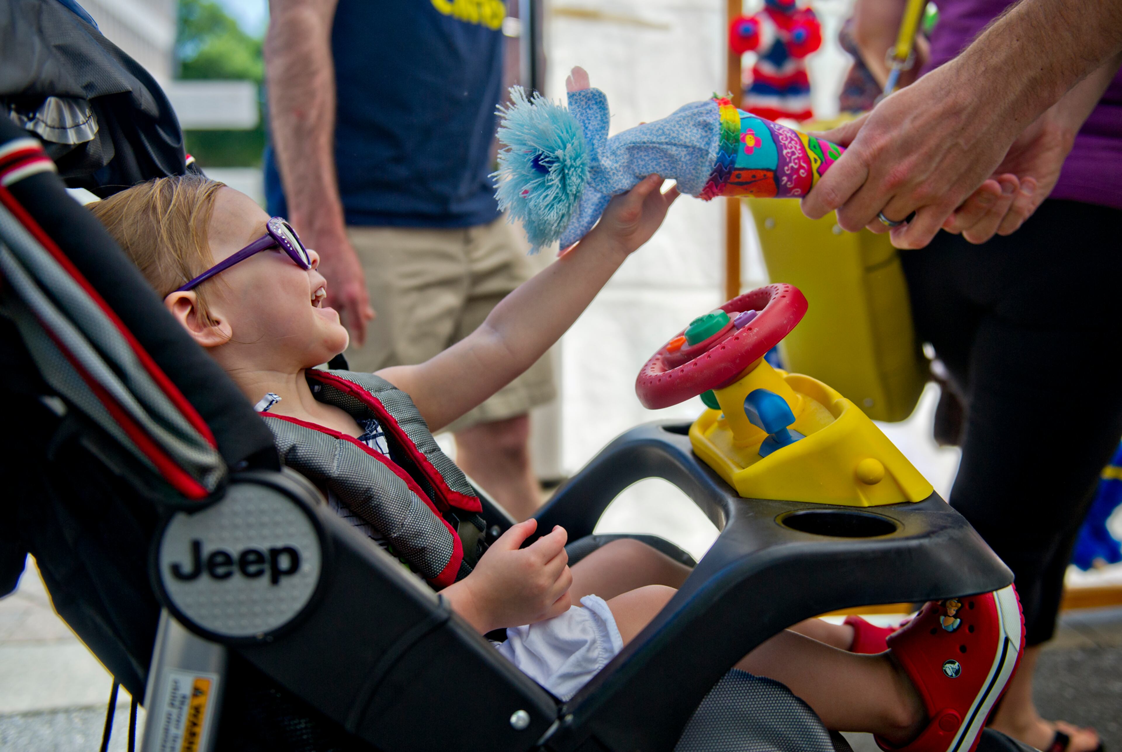 Molly McDonnell (left) laughs as her father Bobby shows her a puppet during the May-retta Daze Arts & Craft Festival at Glover Park in Marietta on Sunday, May 4, 2014.