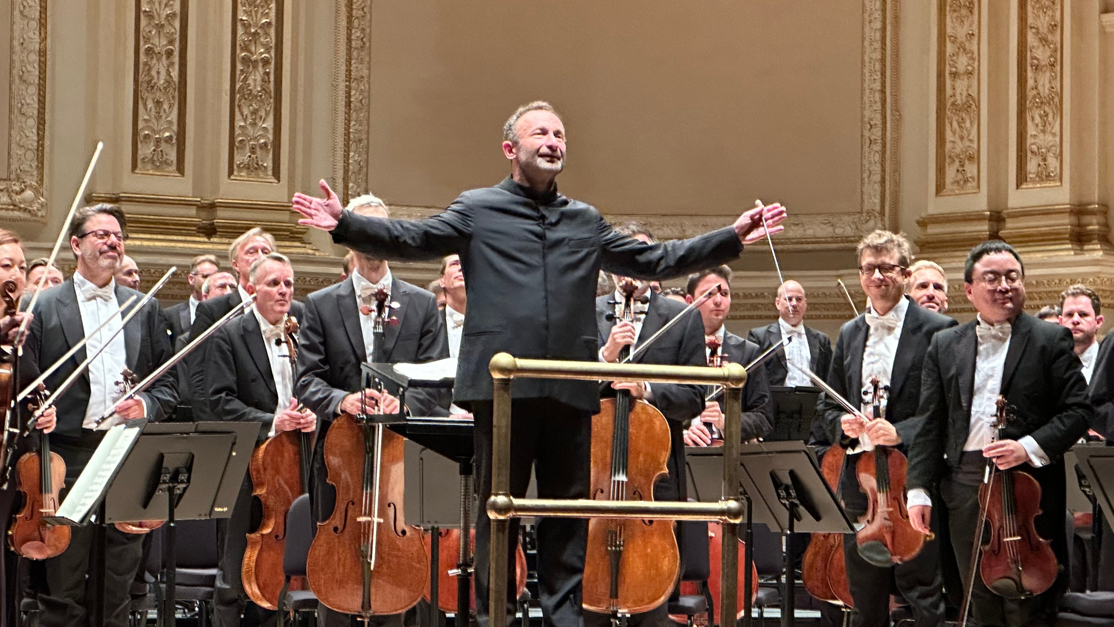 This image taken with a smartphone shows Kirill Petrenko, chief conductor of the Berlin Philharmonic, during a concert with the orchestra at Carnegie Hall in New York on Oct. 10, 2026. (AP Photo/Ron Blum)