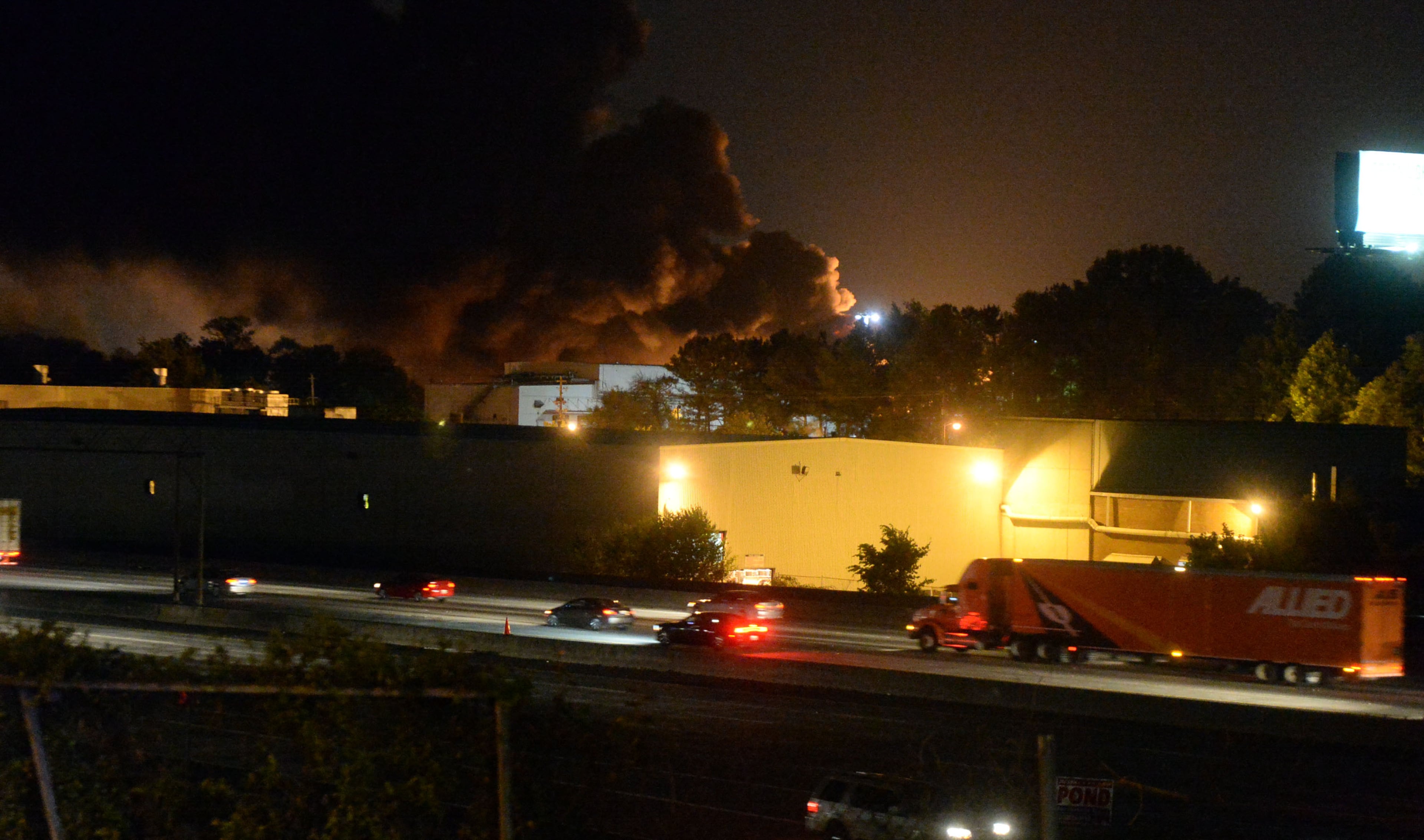 A multiple alarm fire burns in a warehouse just off I-75 in Marietta on Friday, May 23, 2014.
