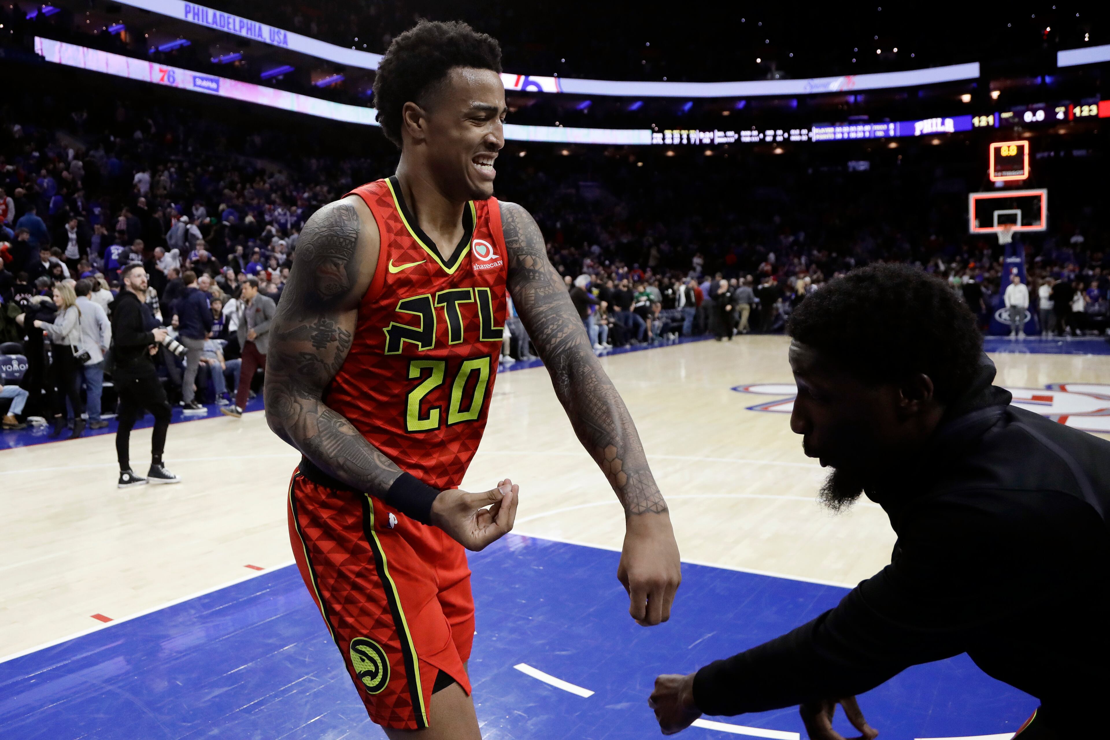 Atlanta Hawks' John Collins, left, celebrates with a teammate after the Hawks defeated the Philadelphia 76ers 123-121 in an NBA basketball game Friday, Jan. 11, 2019, in Philadelphia. (AP Photo/Matt Slocum)