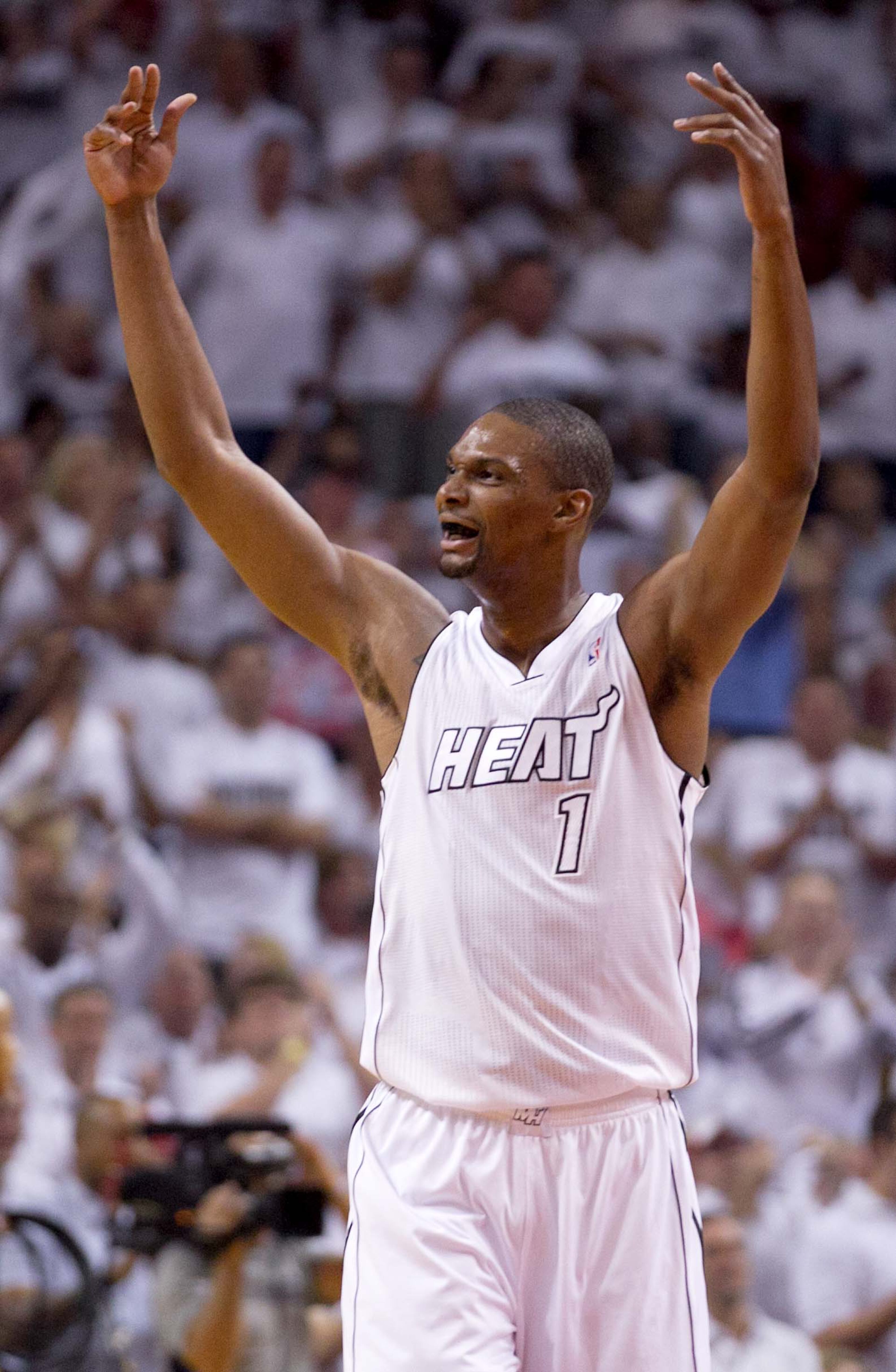 Miami Heat center Chris Bosh (1) gets the crowd excited as the Heat get off to an early lead against the Bucks at AmericanAirlines Arena on April 21, 2013. (Allen Eyestone/The Palm Beach Post)