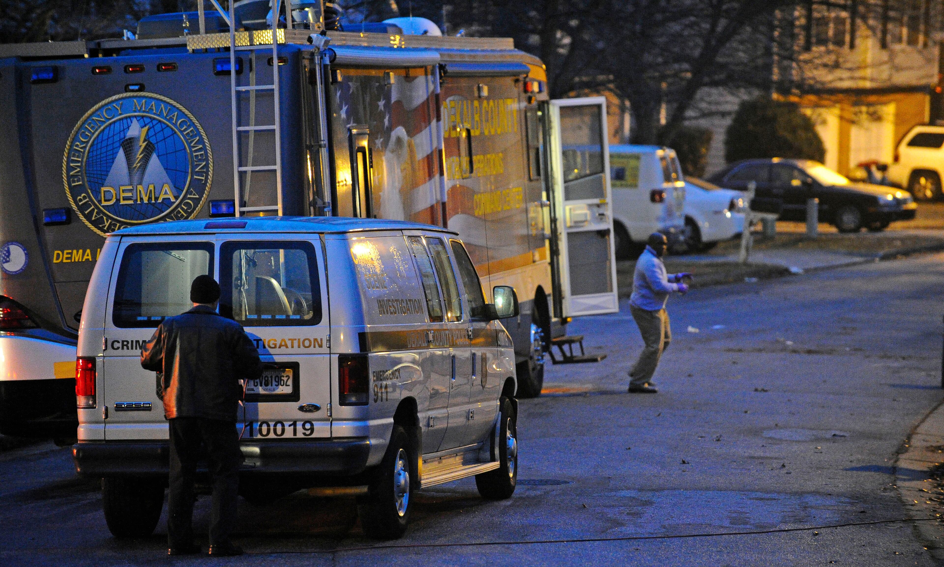 DeKalb police officials investigate the scene on Landgraf Cove, in a neighborhood off River Road, where a gunman fired shots at SWAT team officers during a five-hour standoff early Monday morning, Dec. 22, 2014, in the southern part of the county. When officers entered the house, the gunman was found dead. DAVID TULIS / AJC SPECIAL